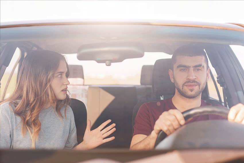 wife tells something emotionally to her husband who drives car