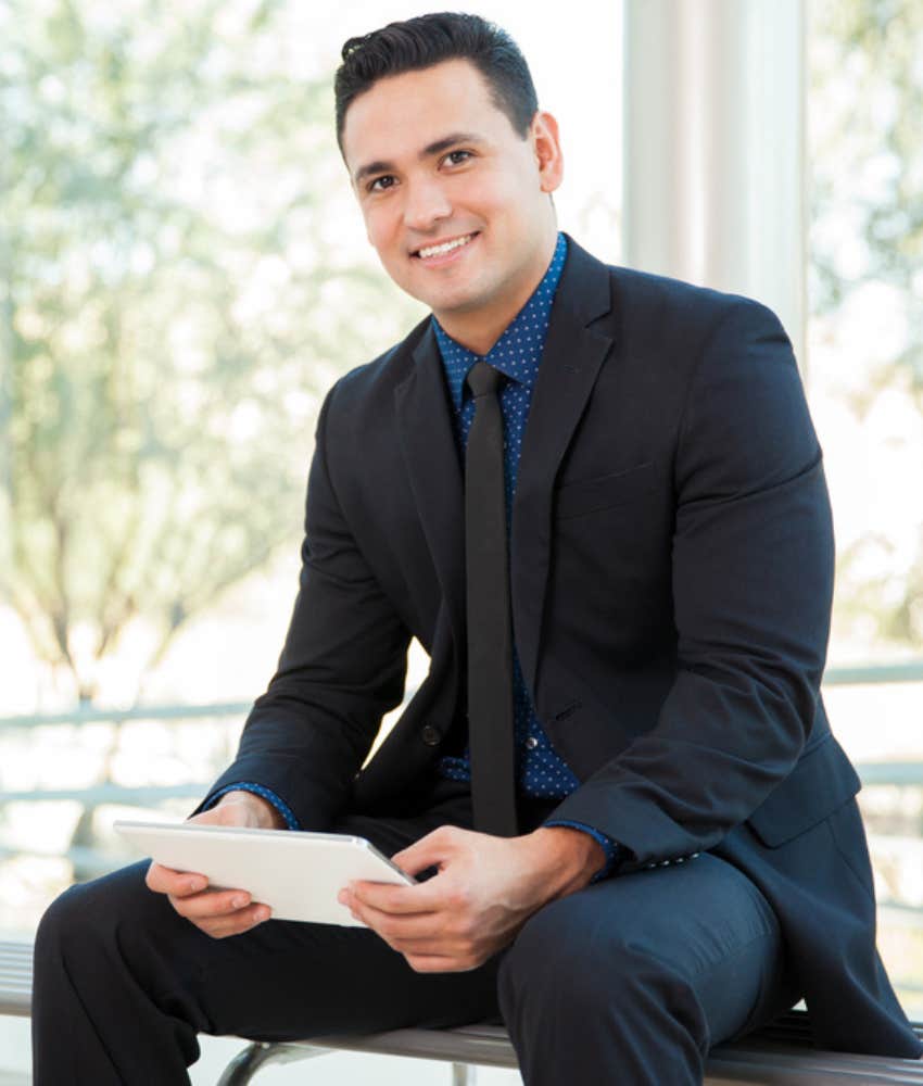 Young man smiling in suit before job interview