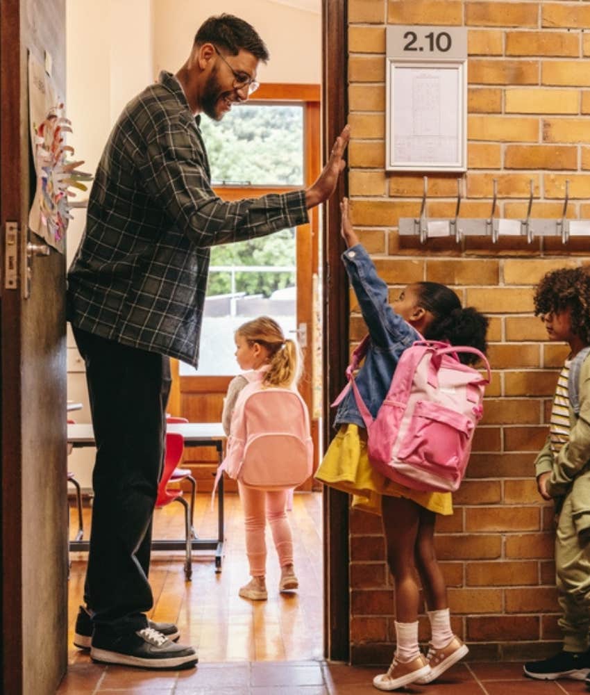 young teacher greeting students in casual clothes