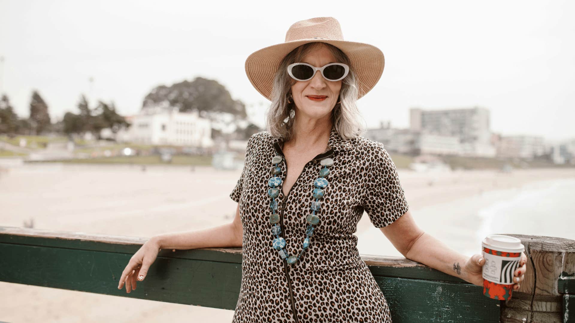 middle aged woman in sunglasses and sunhat