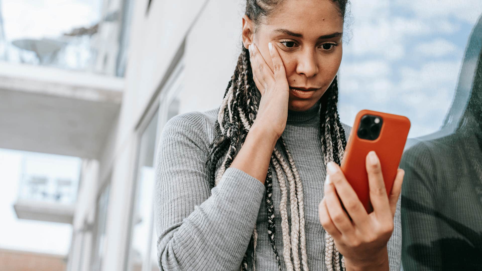 woman staring nervously at phone