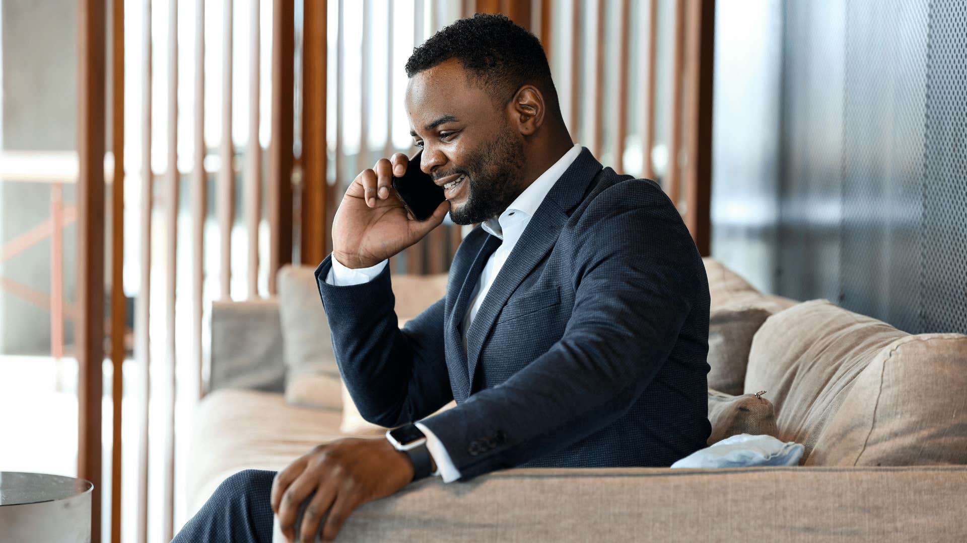 man in suit talking on phone