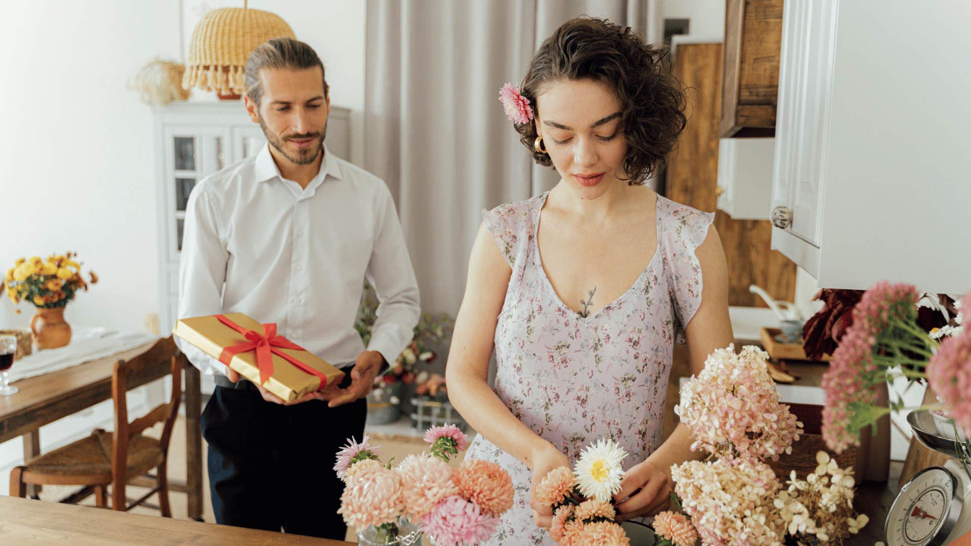 man surprising woman with gift