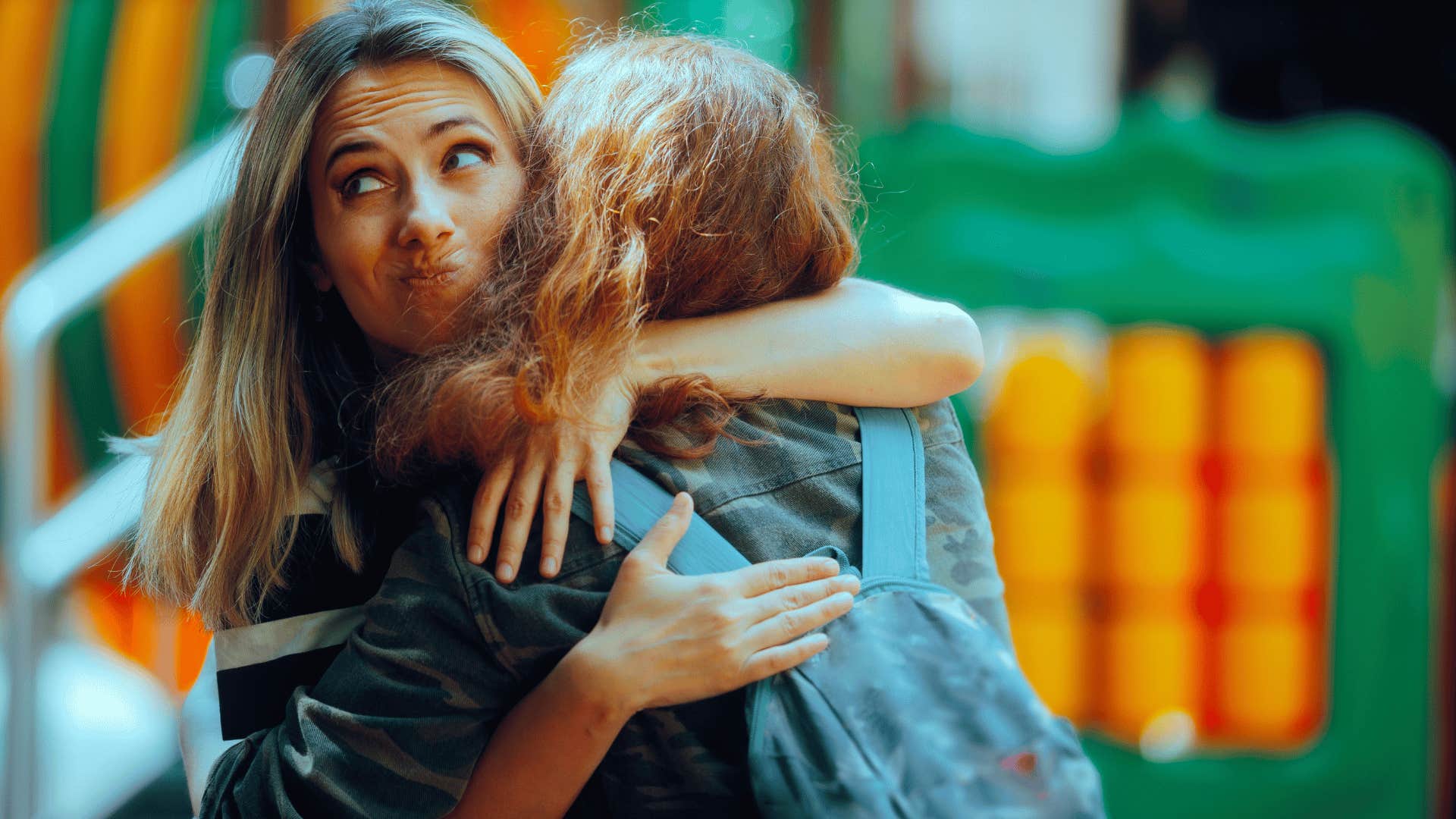 girl making a face behind friends back