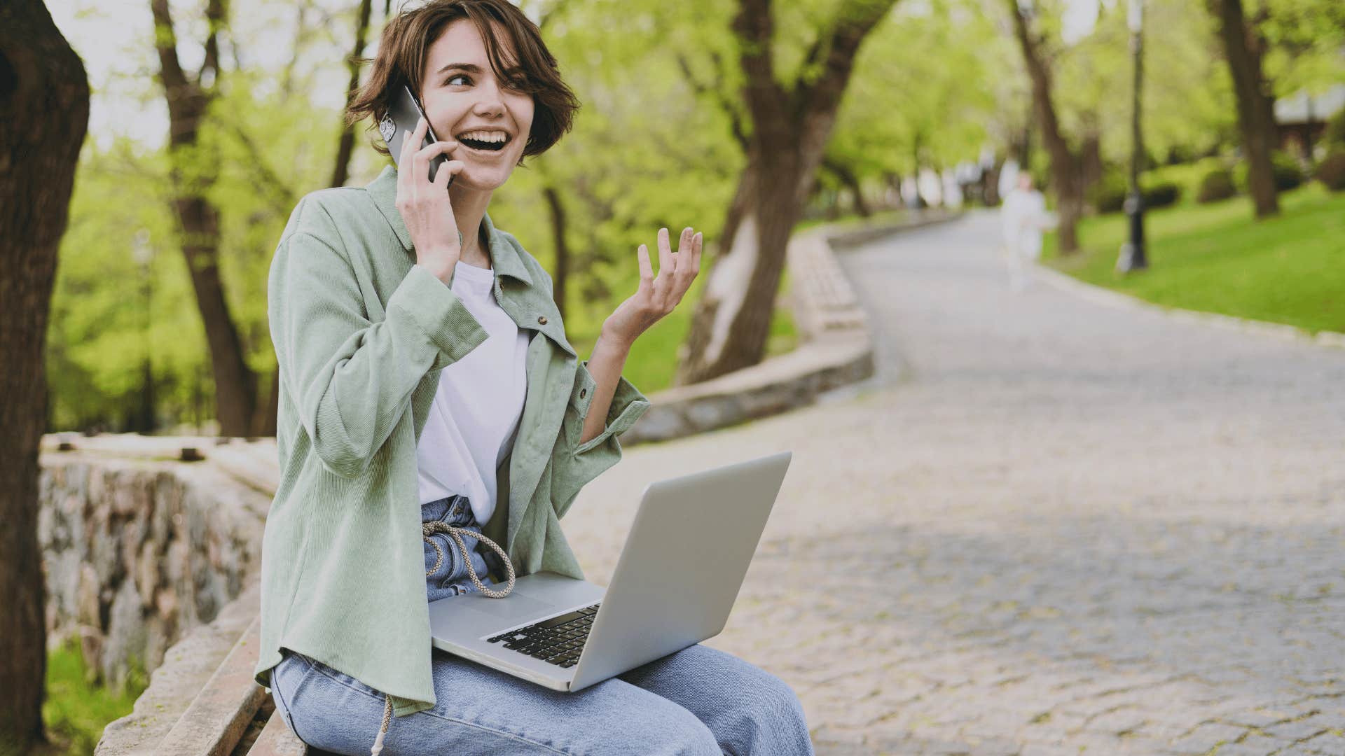 excited young woman speaking on phone