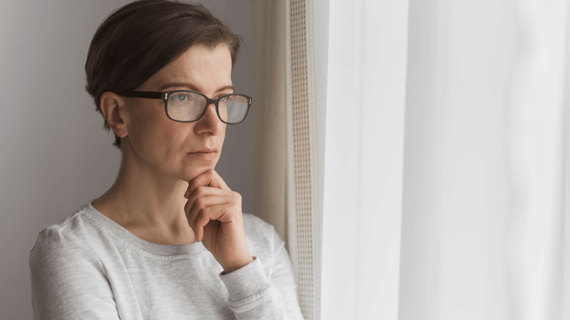 contemplative woman looking outside