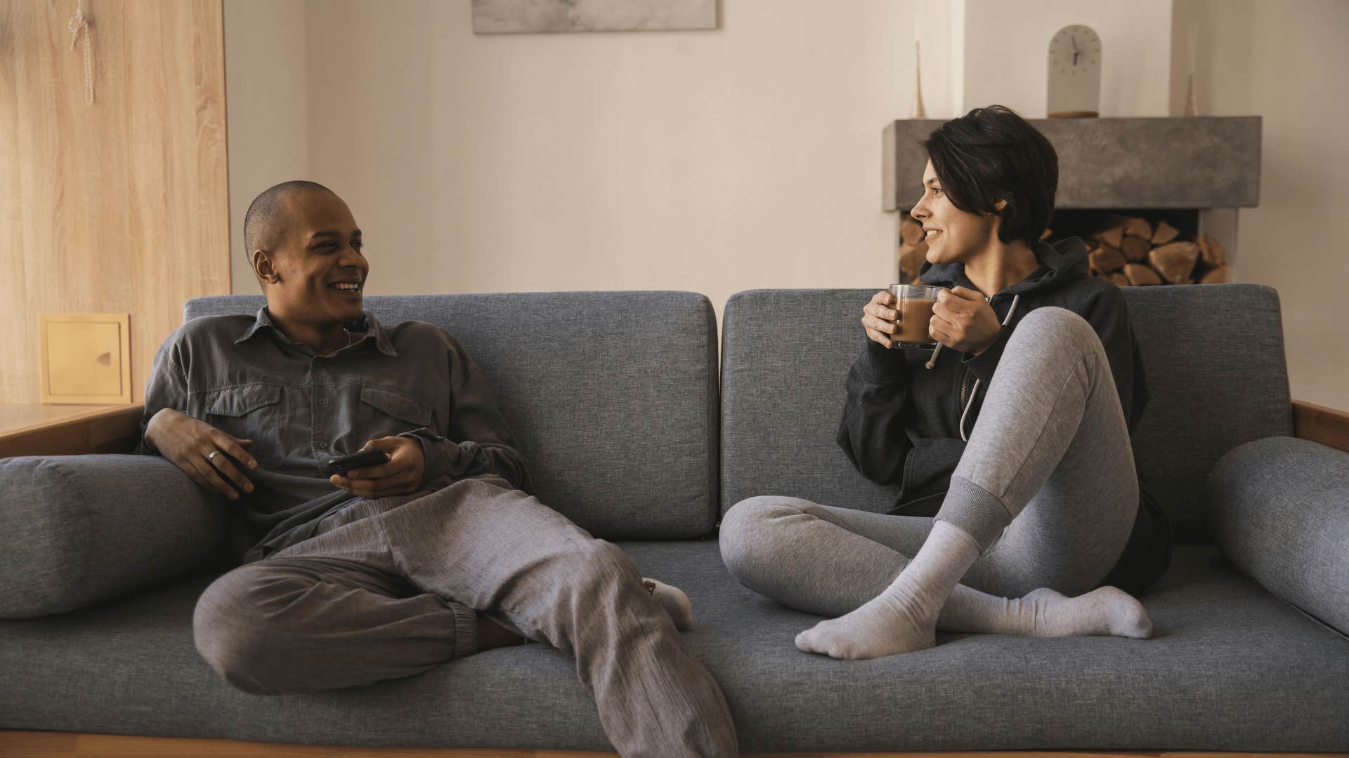 couple lounging and chatting on couch