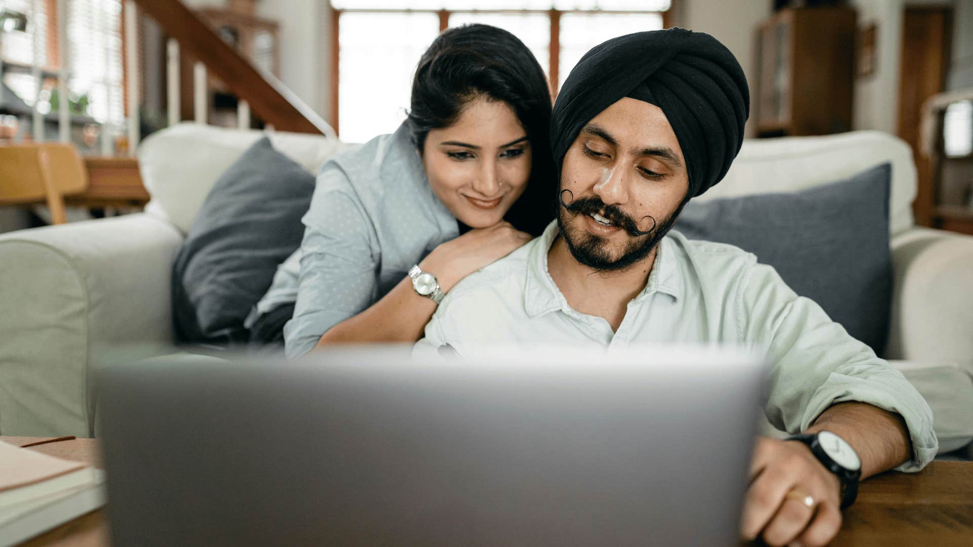 couple looking at open laptop together