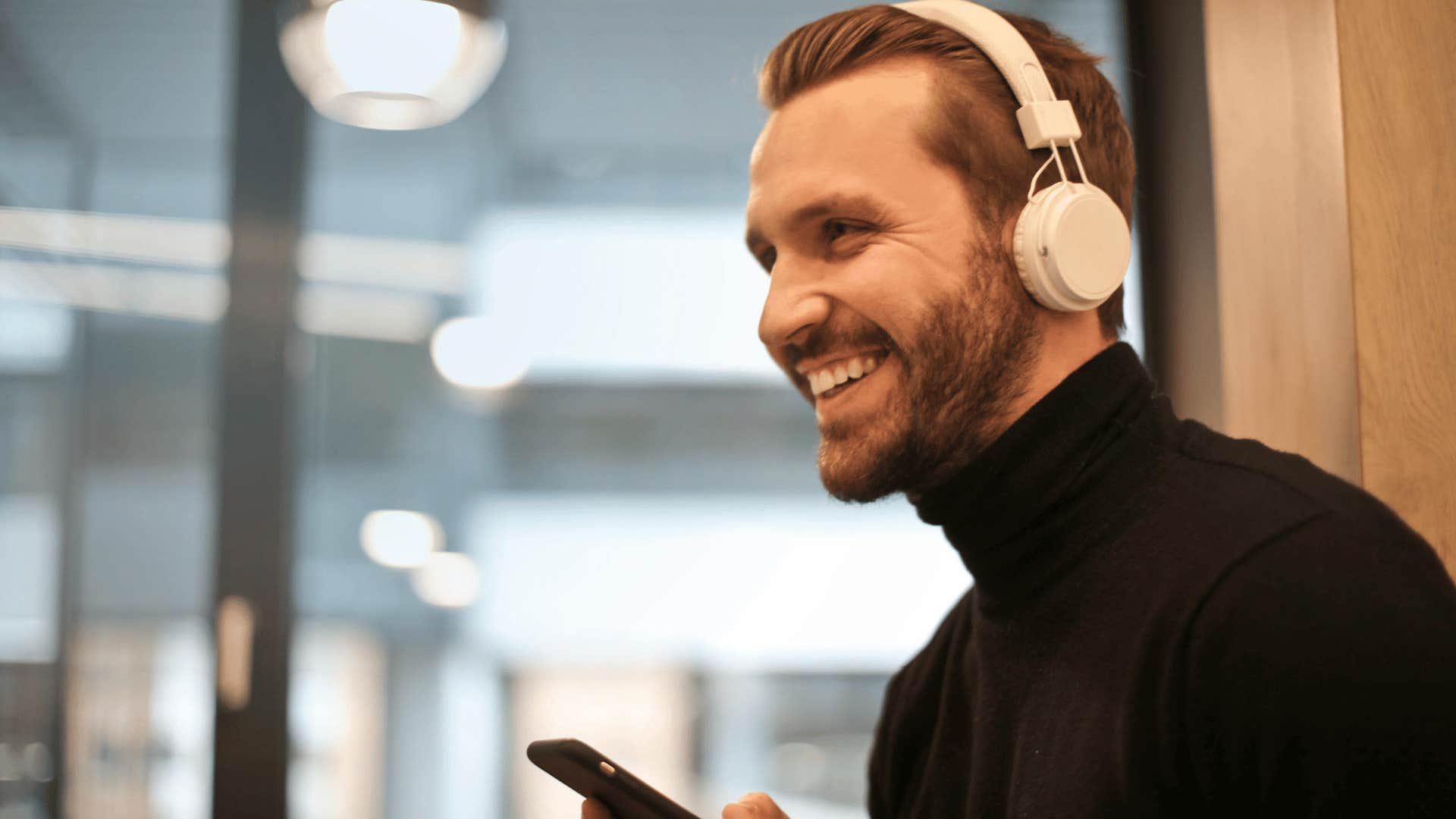 smiling man wearing headphones