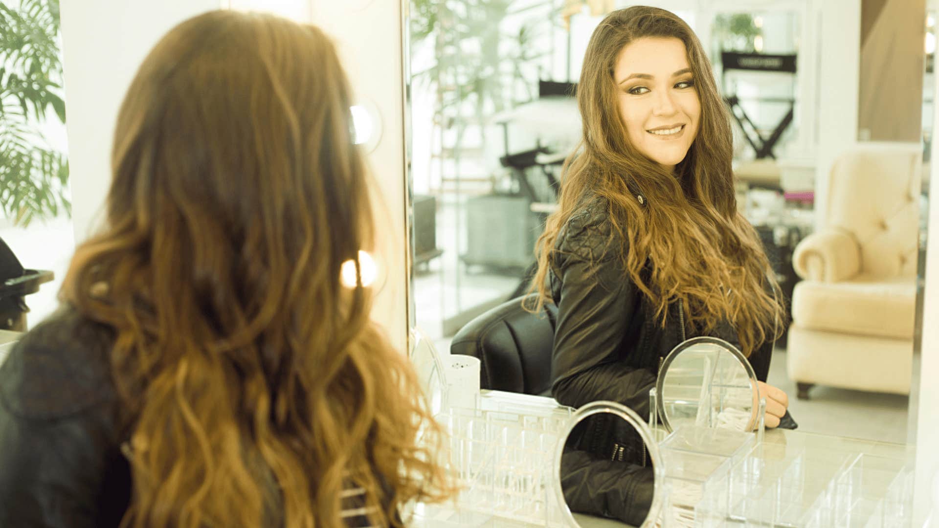 woman smiling at her own reflection