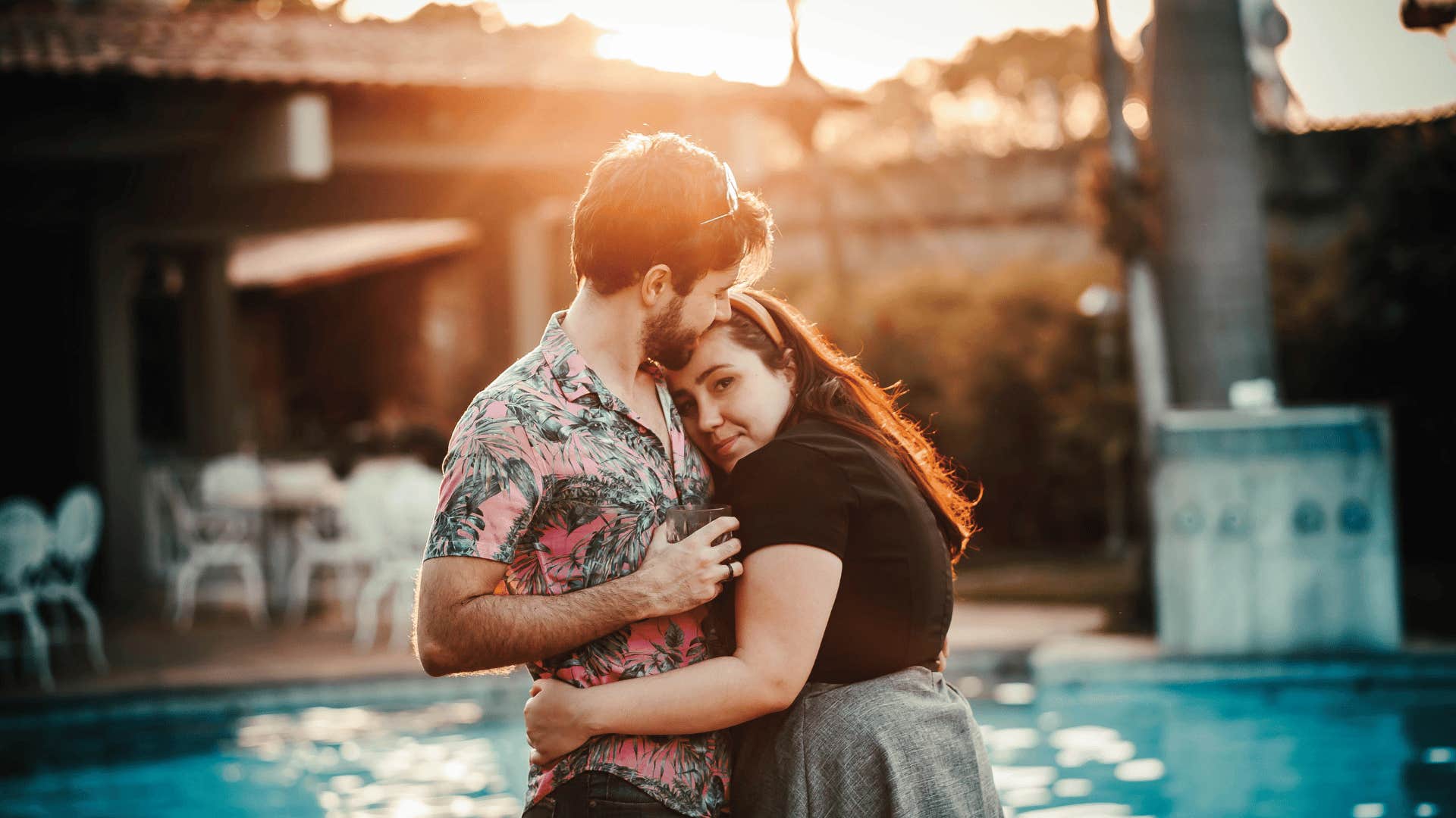 couple hugging near a swimming pool