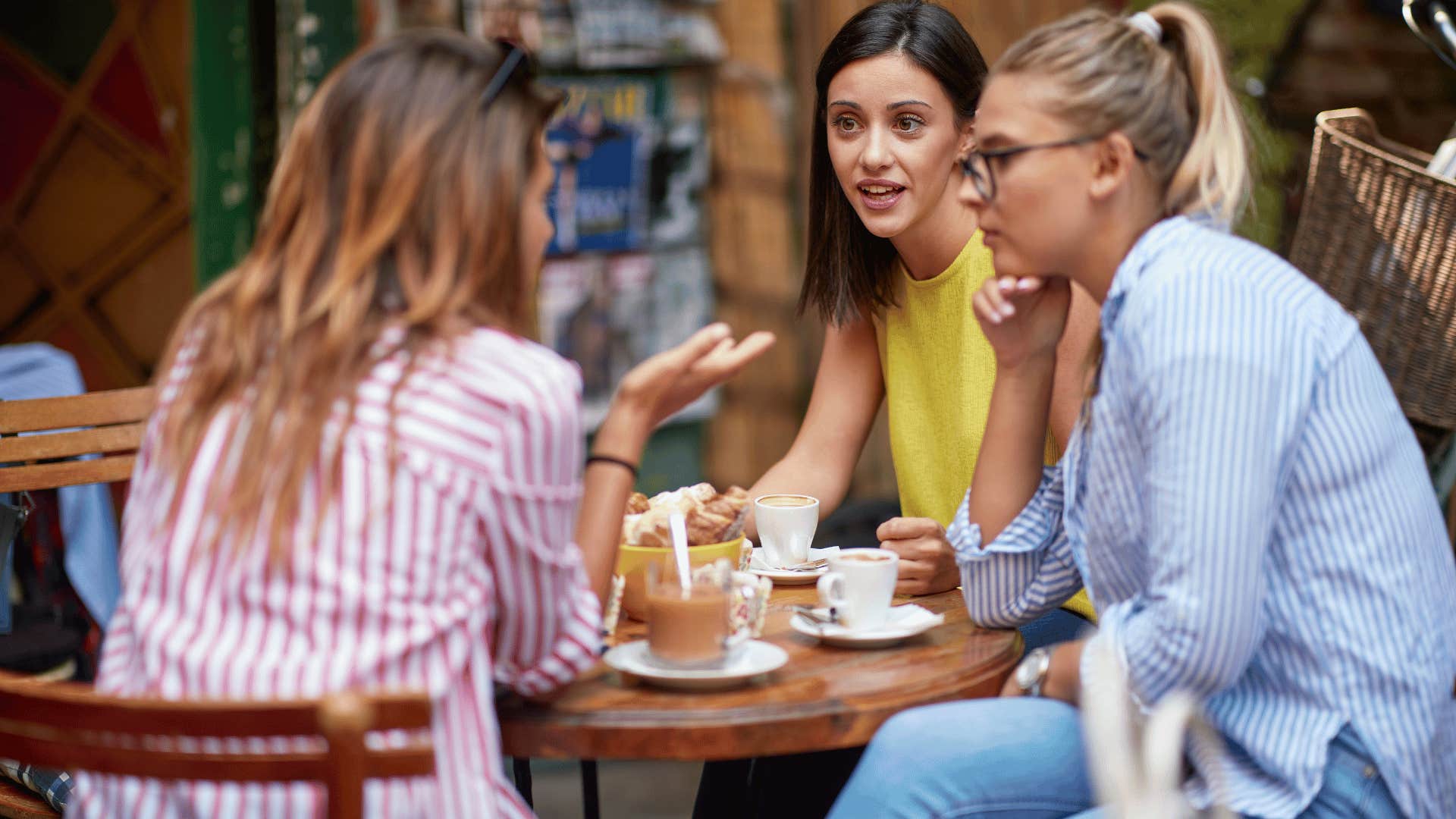 group of women talking at a cafe