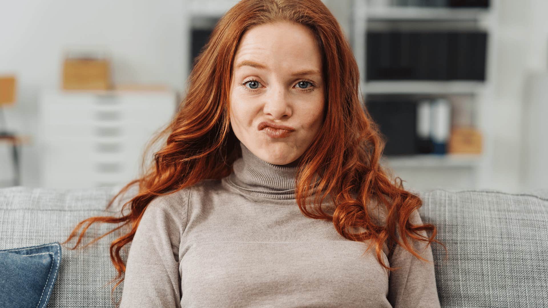 redhead woman making a silly face at the camera