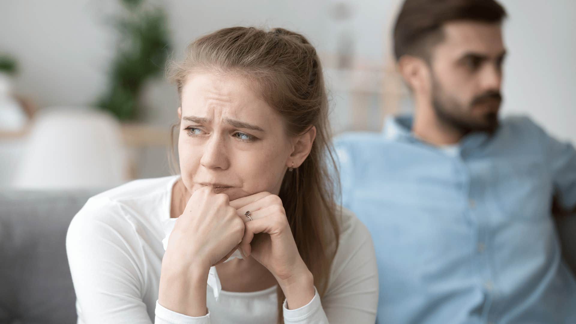 woman crying and hiding tissue in hand