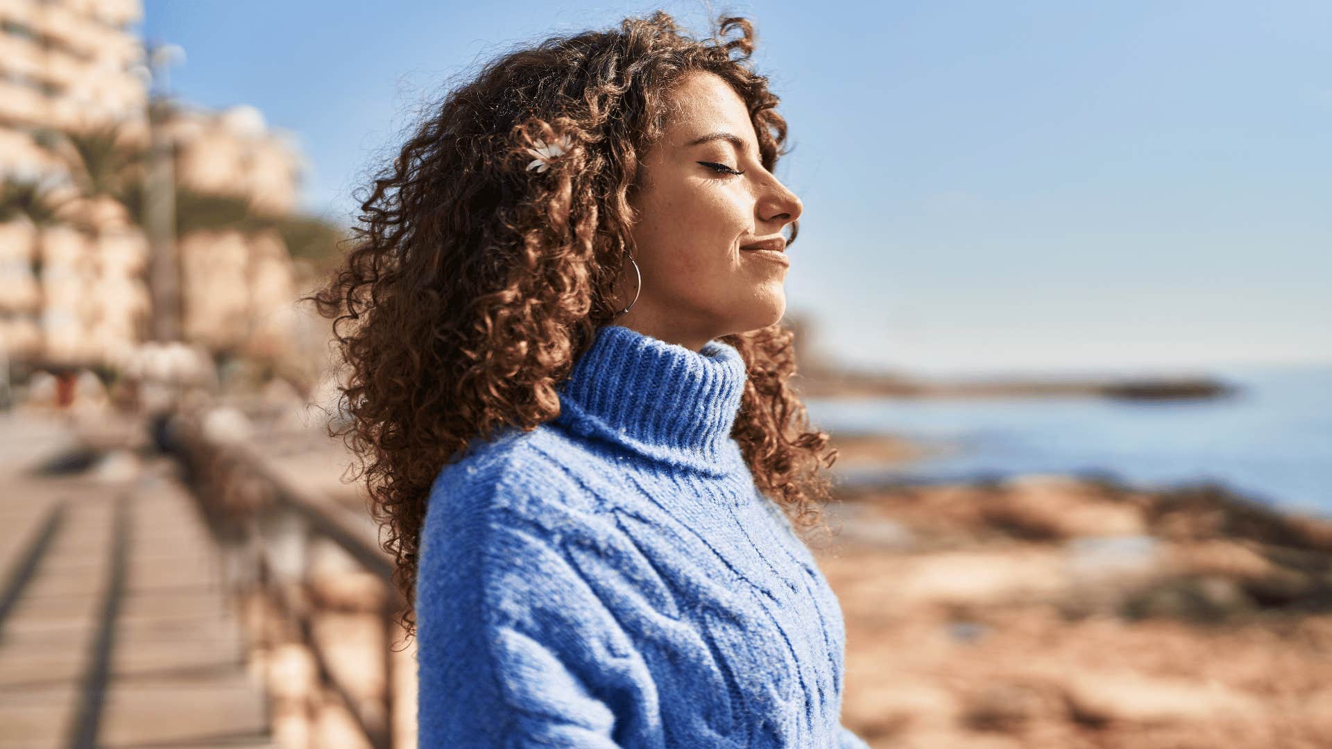 woman in knit sweater standing outside