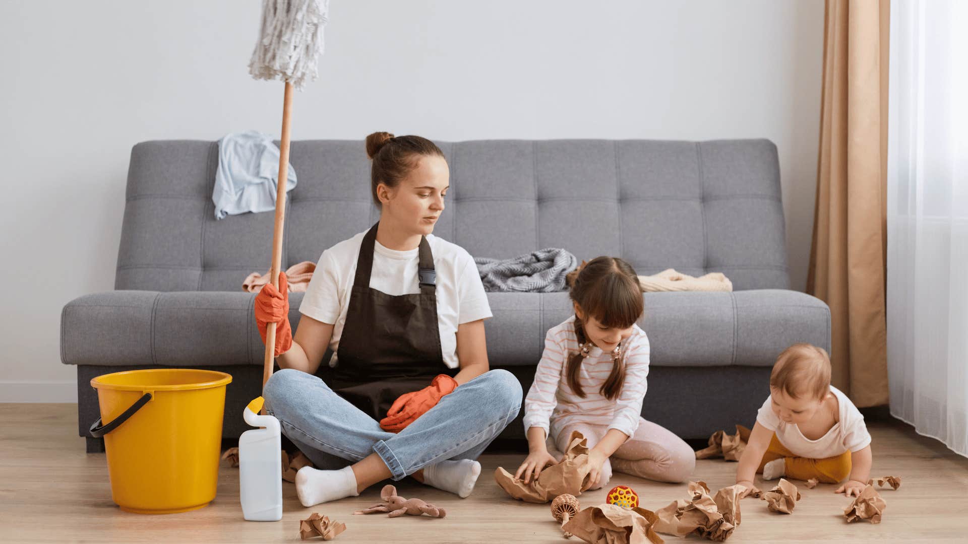 woman trying to clean as kids make mess