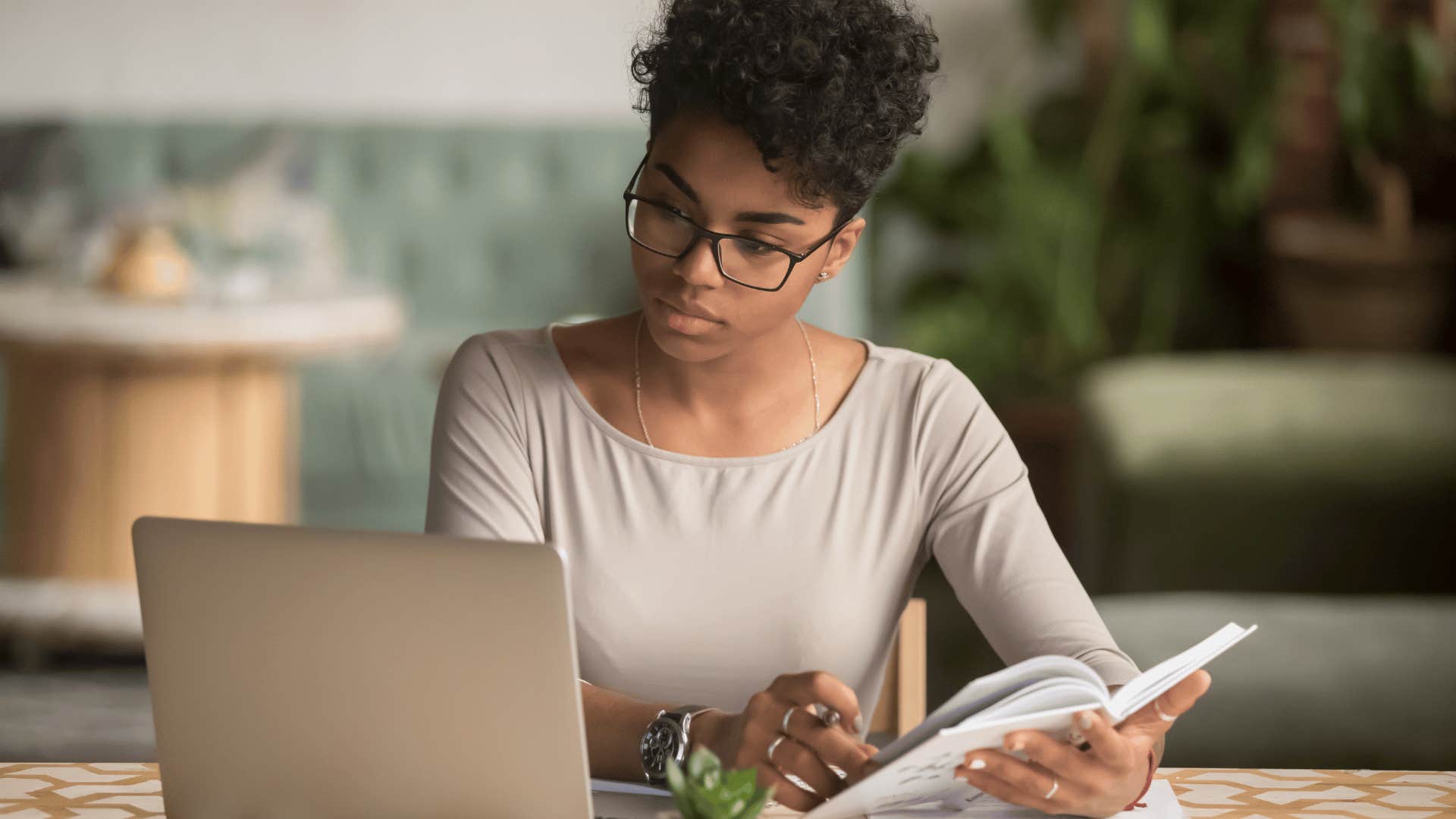 young woman focused on open laptop