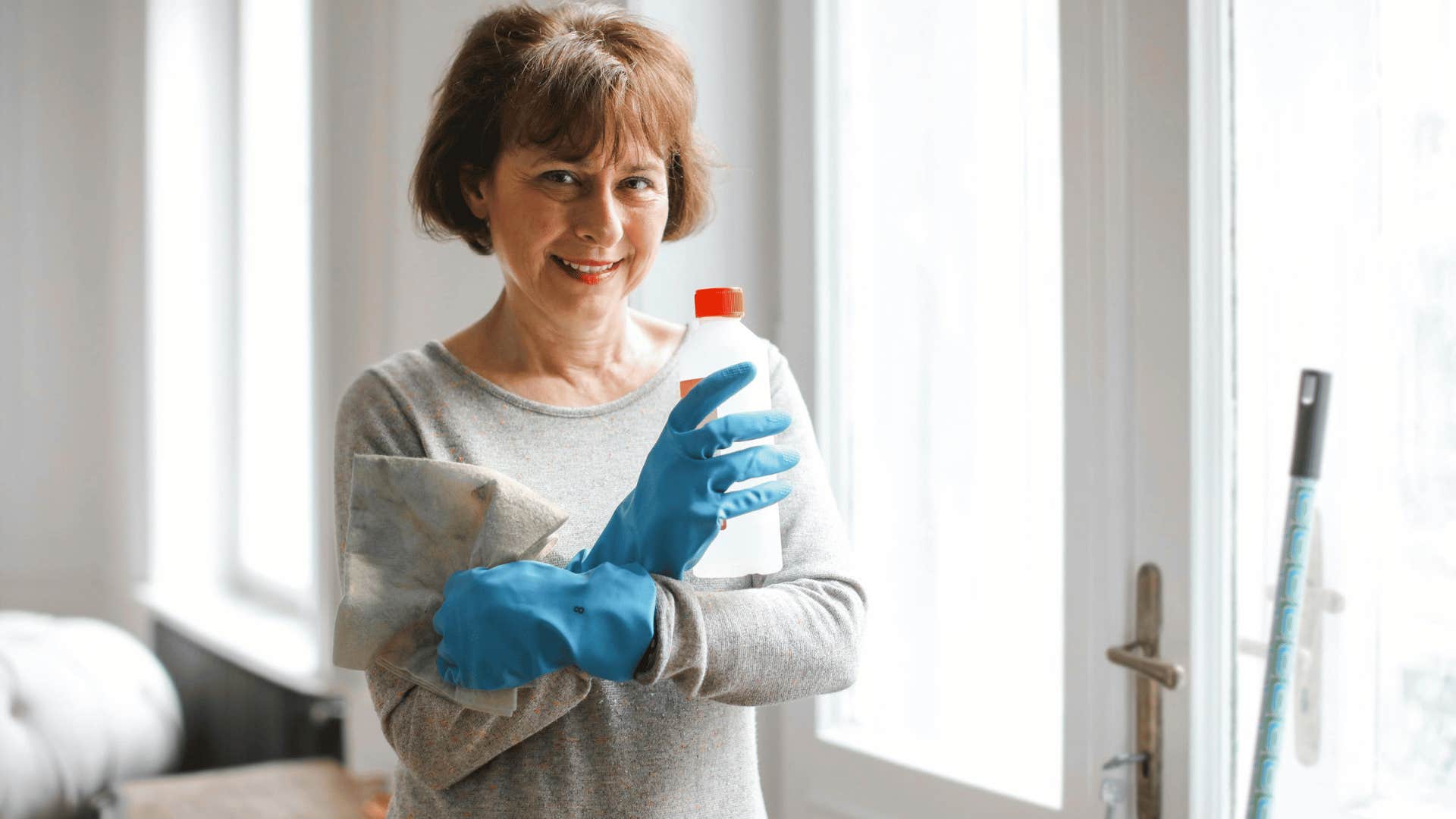 housekeeper wearing rubber cleaning gloves