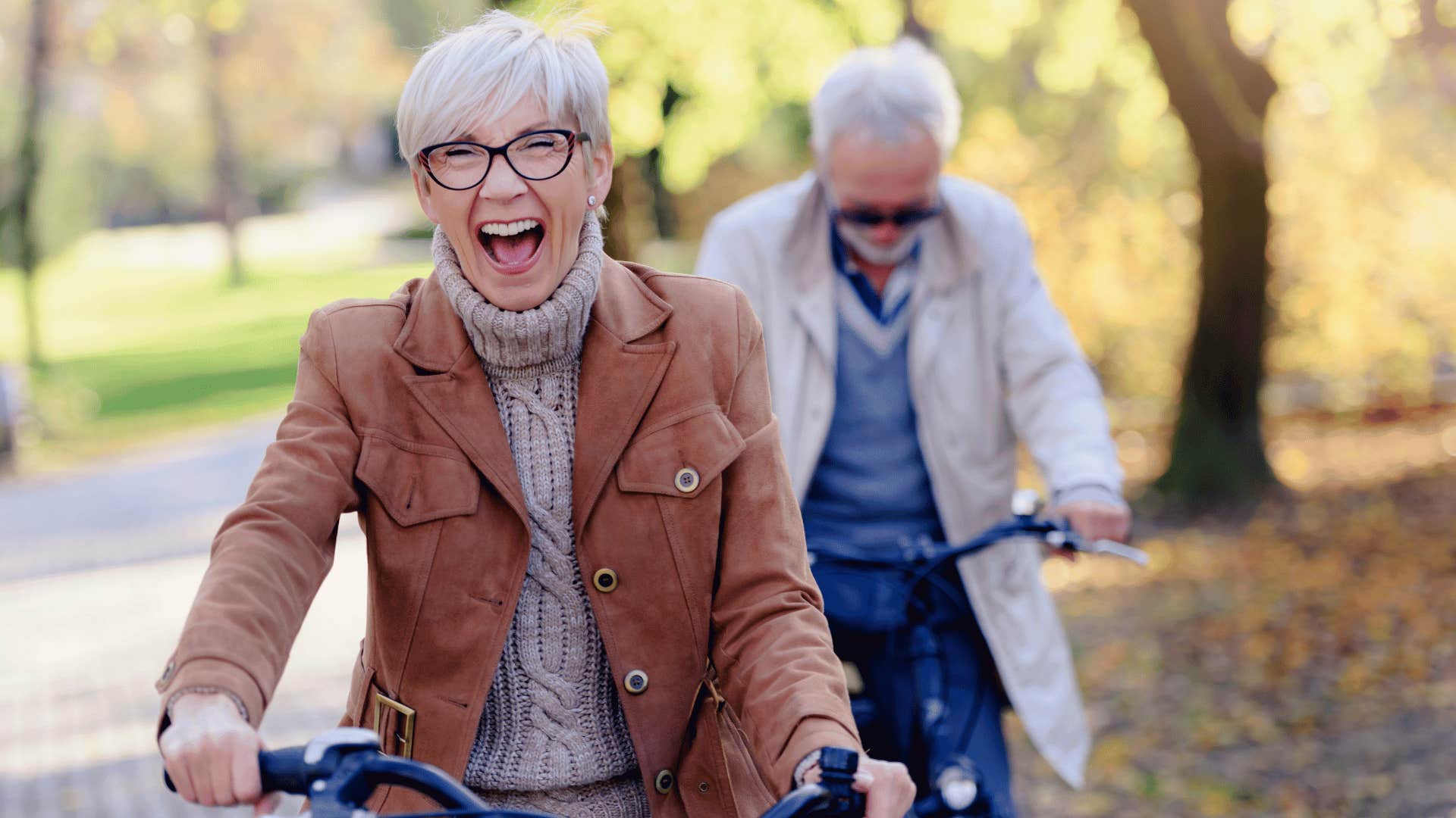 laughing older woman riding bike