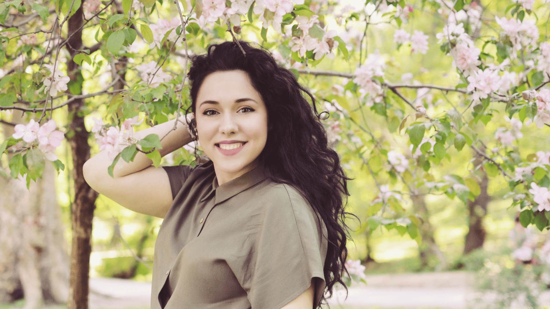 smiling woman under a tree