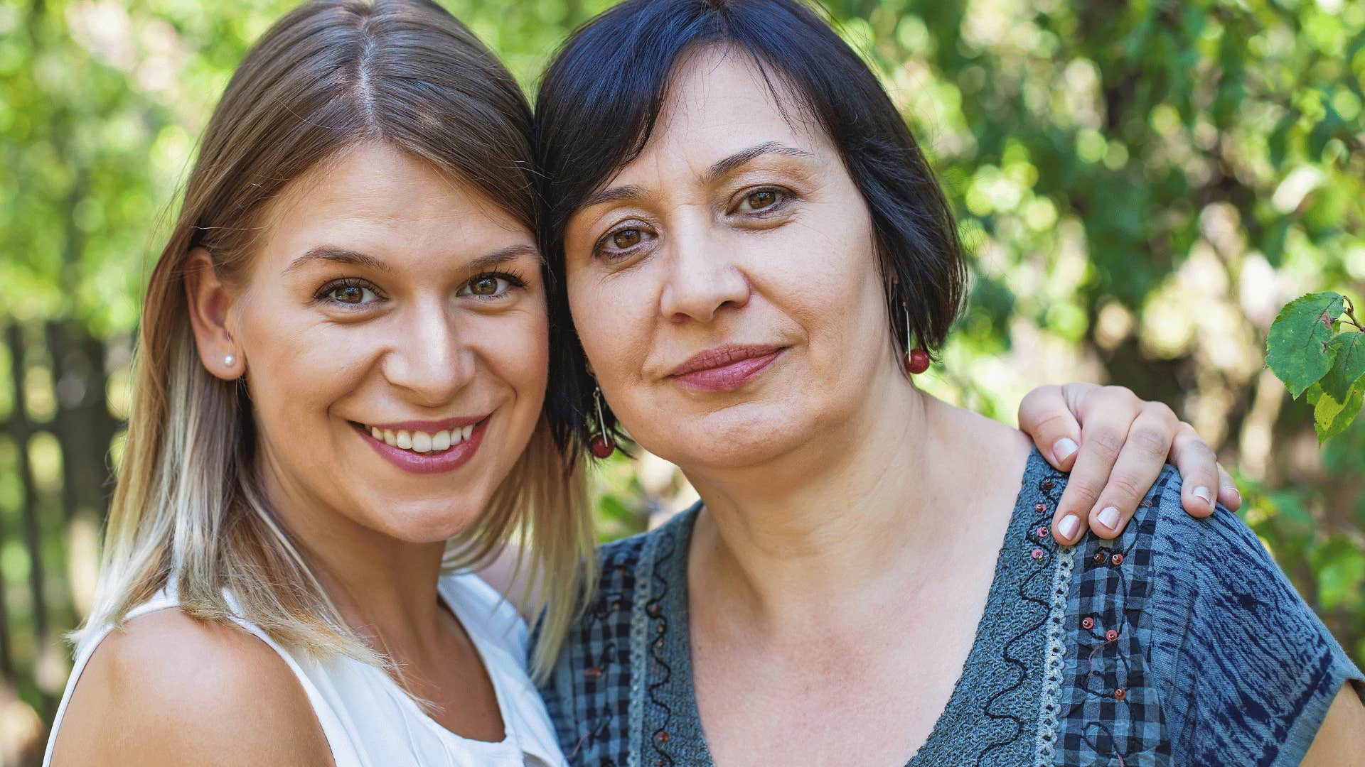 young woman embracing middle aged woman