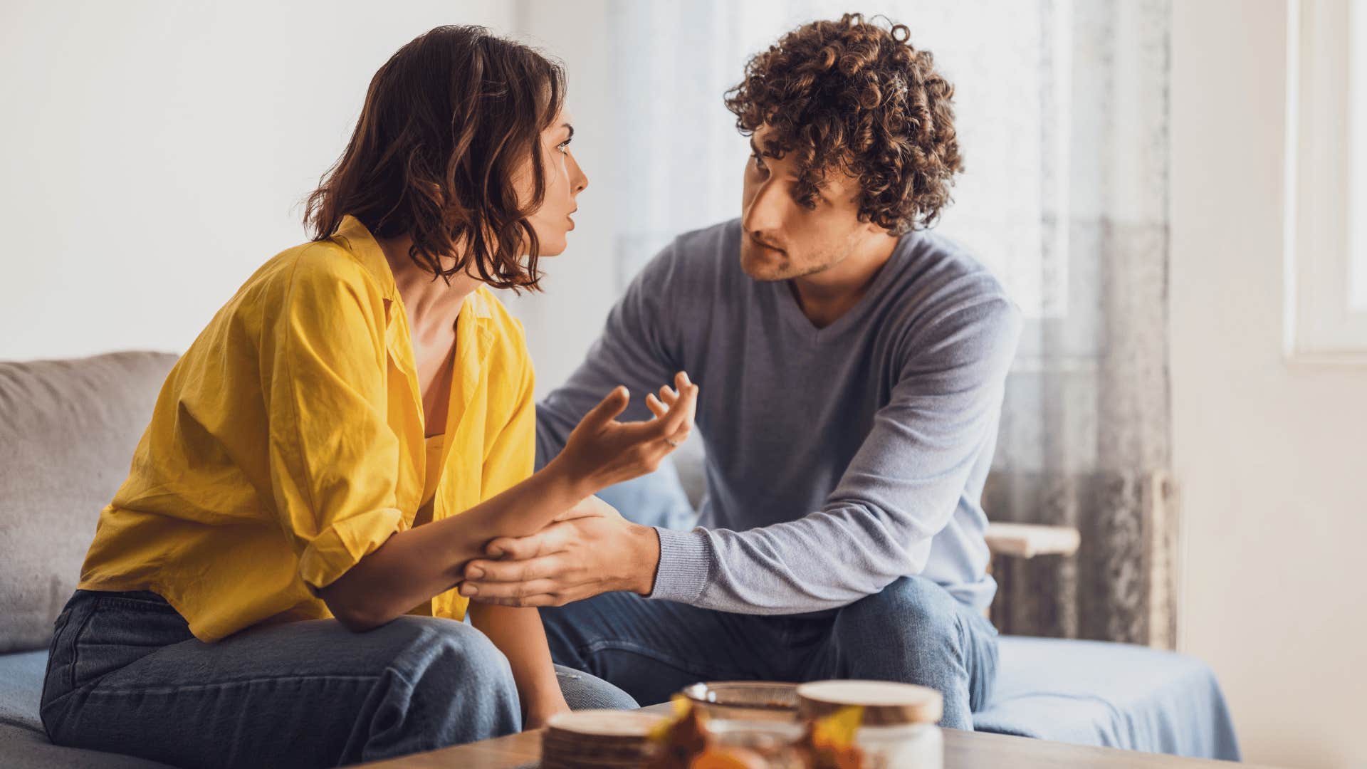 couple having conversation on couch