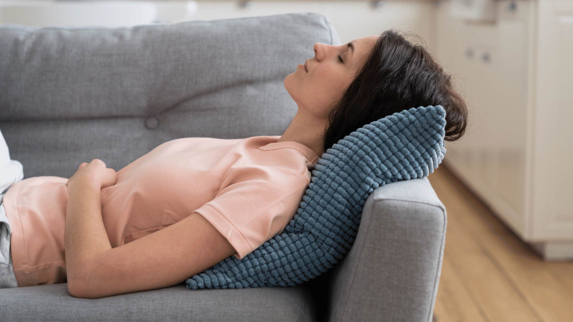 woman laying back on pillow