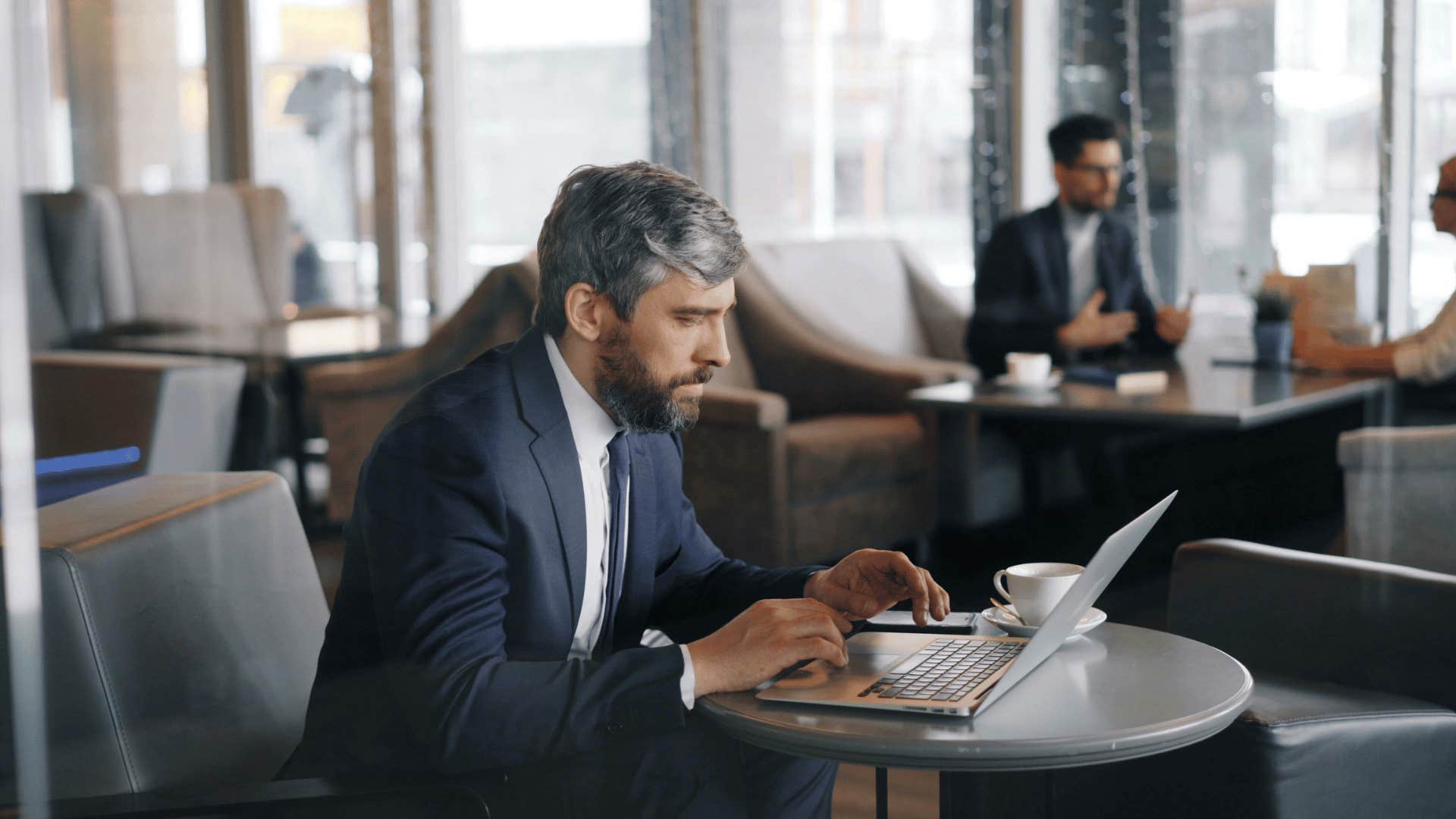 businessman working on laptop at cafe