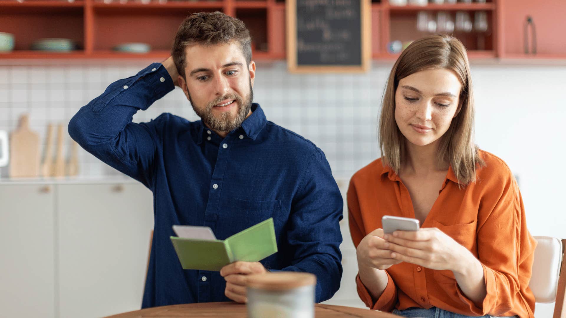 embarrassed man on date looking at check