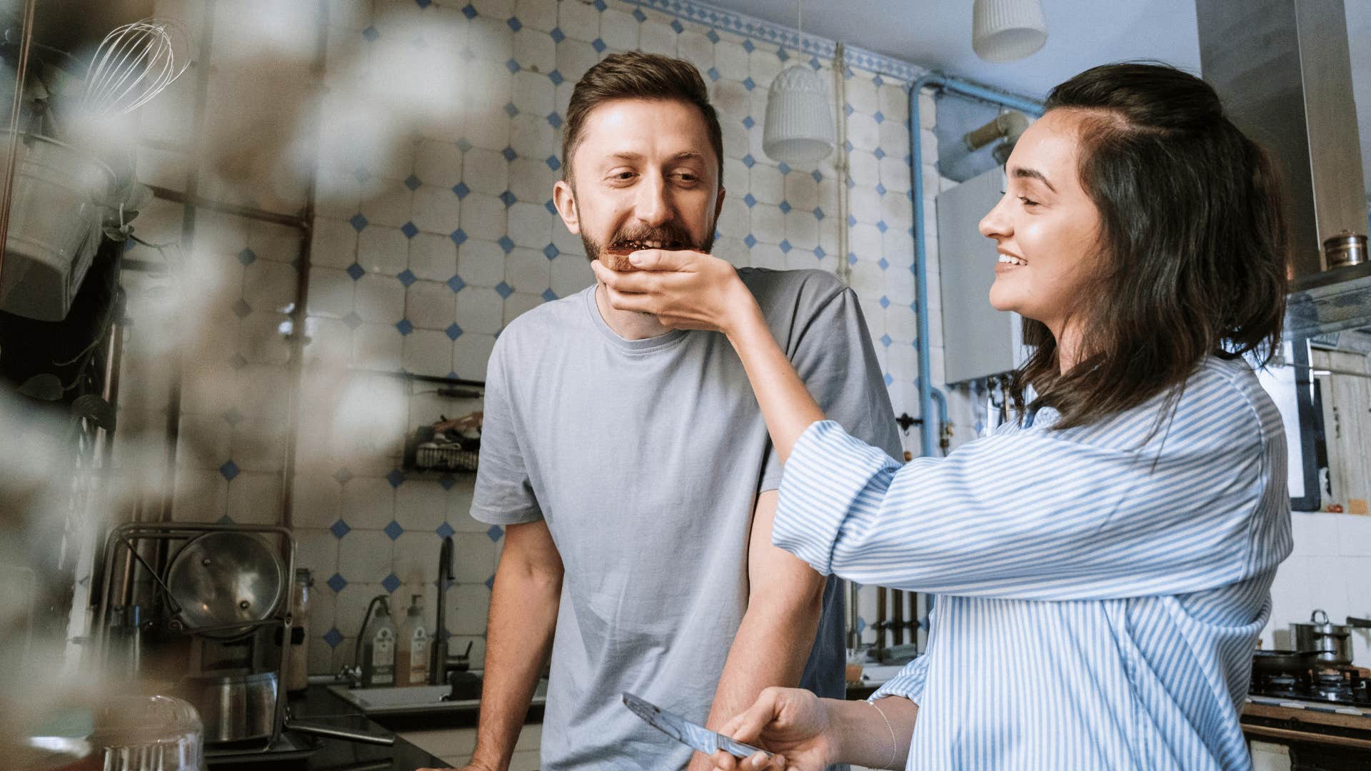 woman feeding man piece of toast