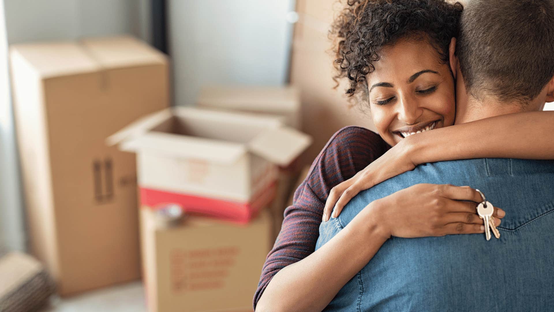 woman holding keys and hugging man