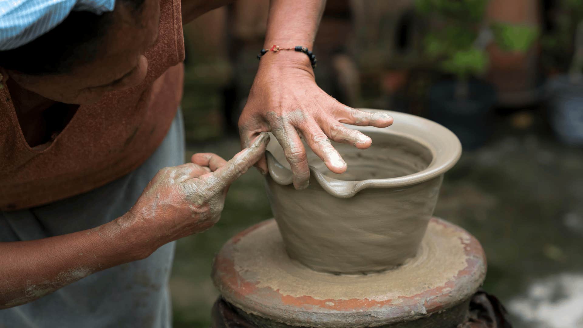 woman working on pottery