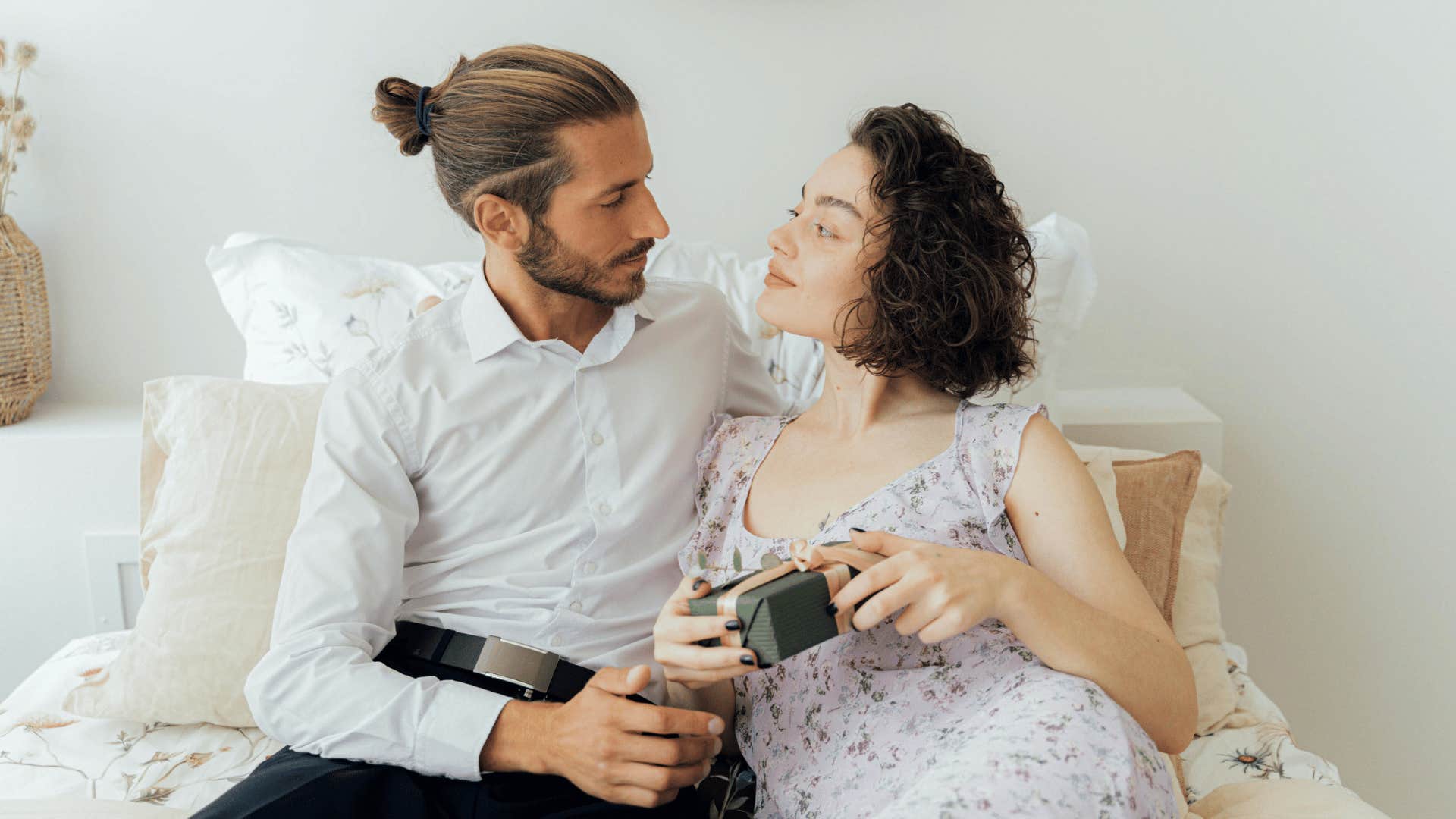 man handing gift to woman