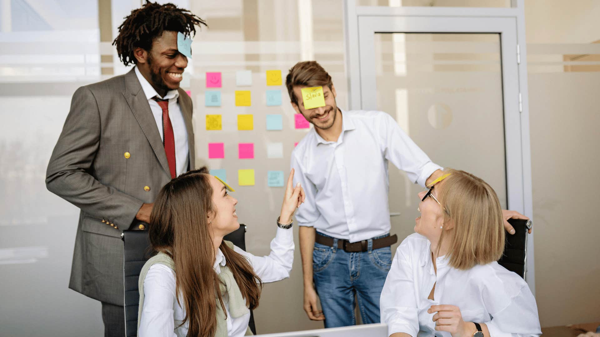 playful work team with stickies on their foreheads