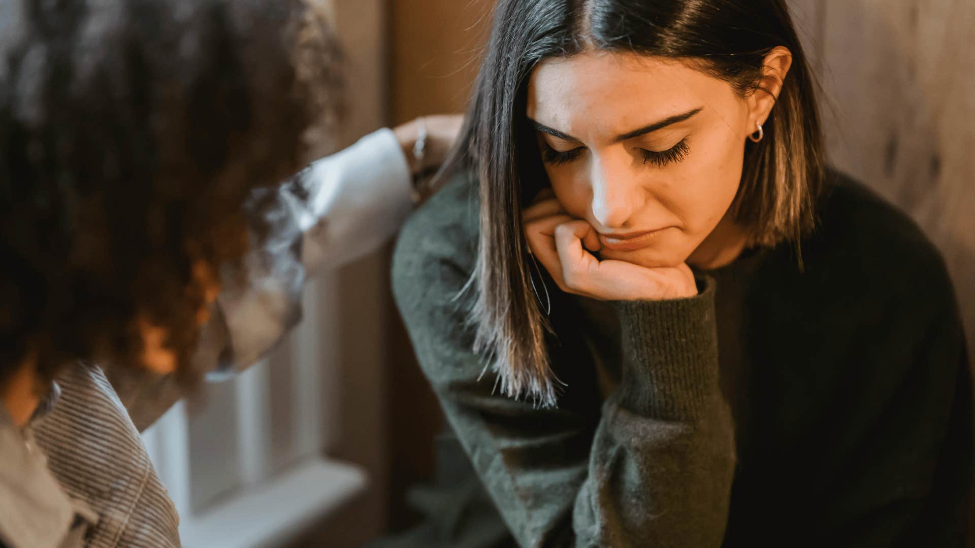 woman comforting sad woman