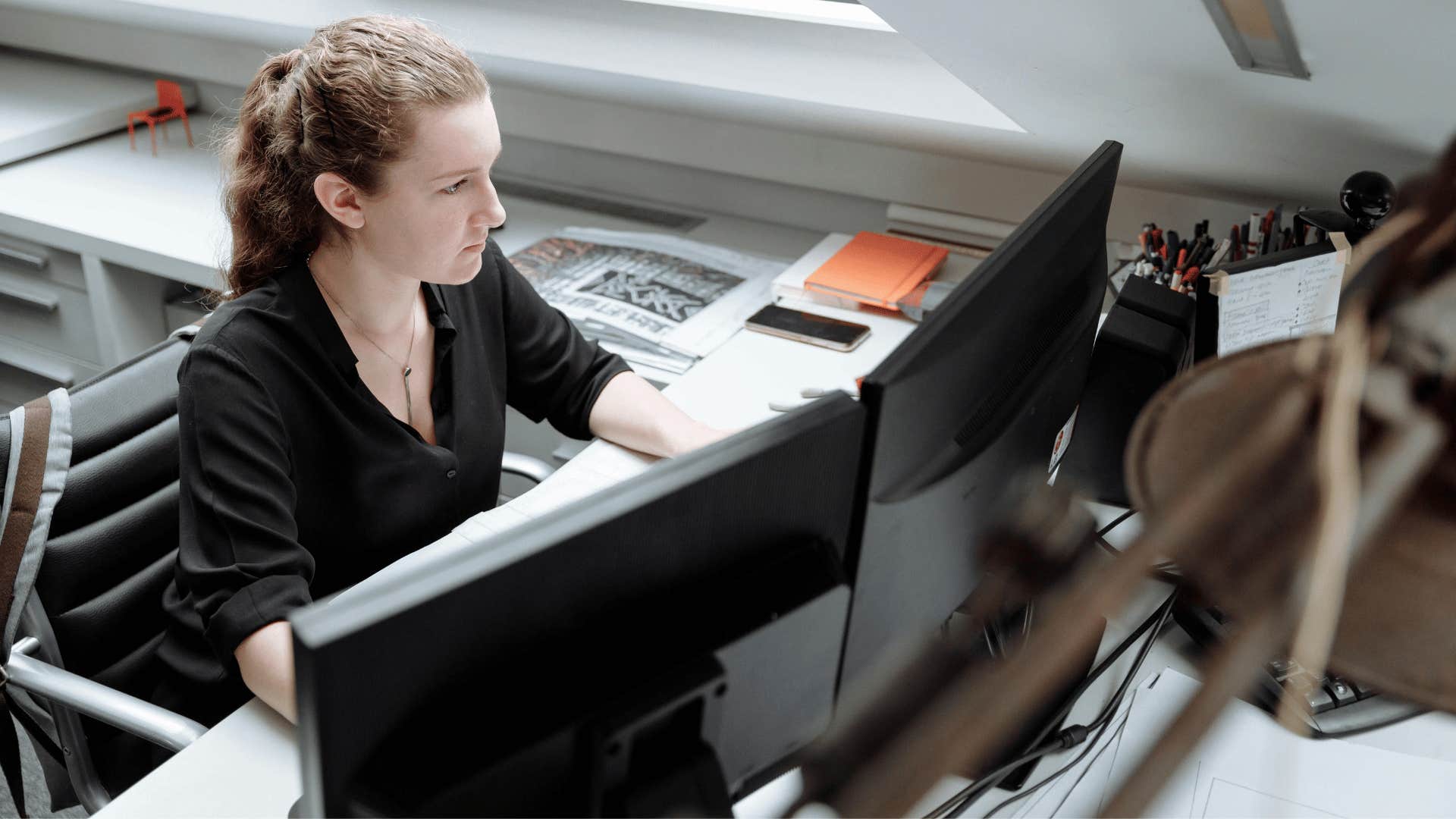 woman working on two screens