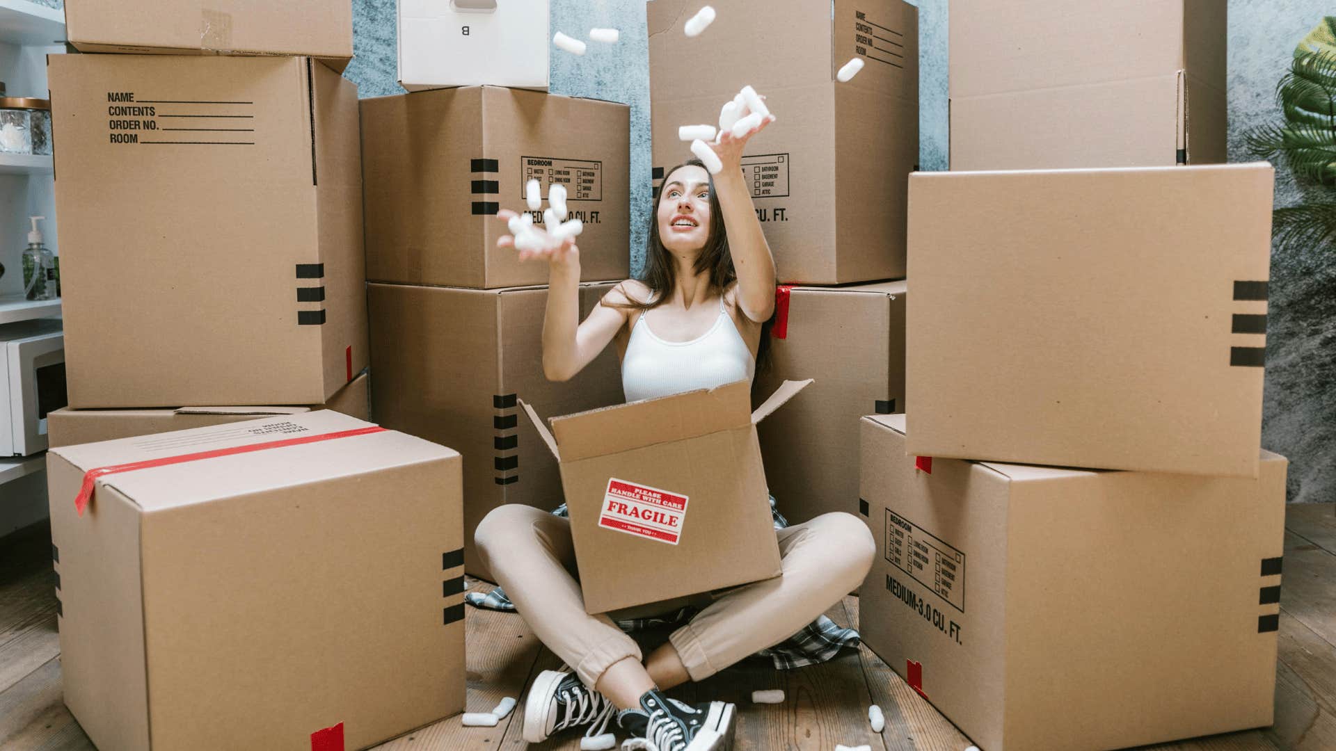 young woman in front of moving boxes