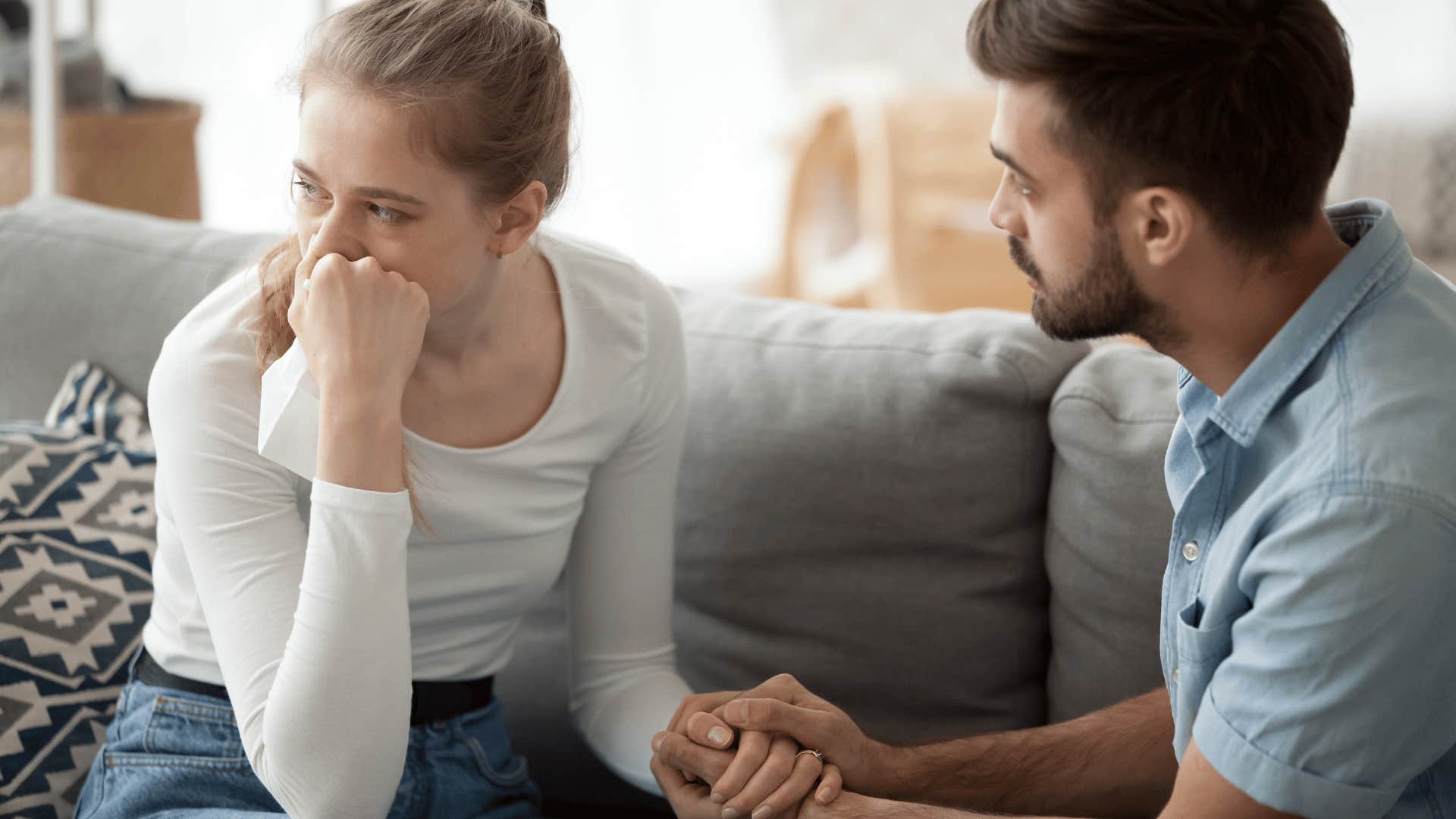 man comforting upset woman