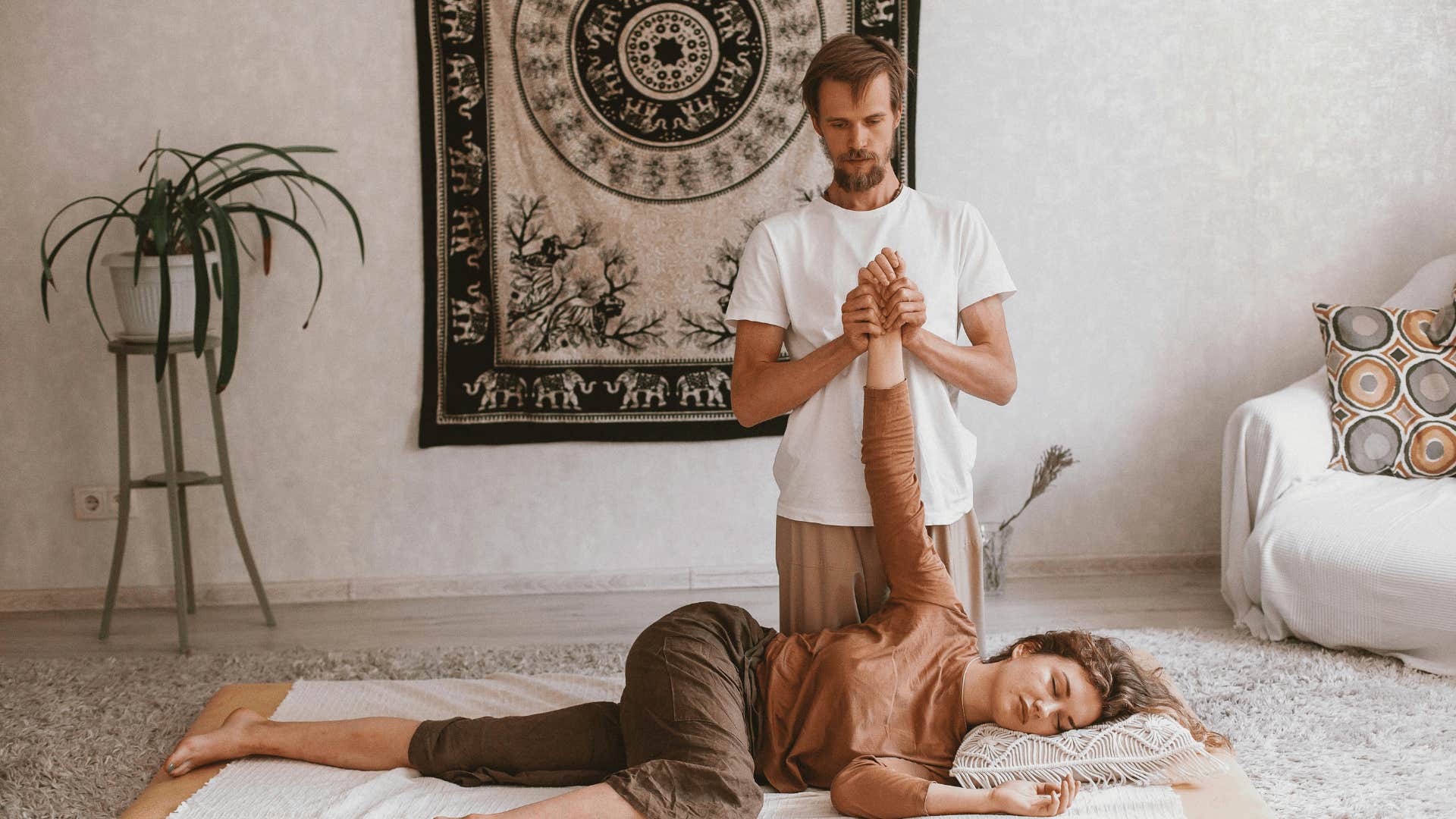 man massaging woman's wrist