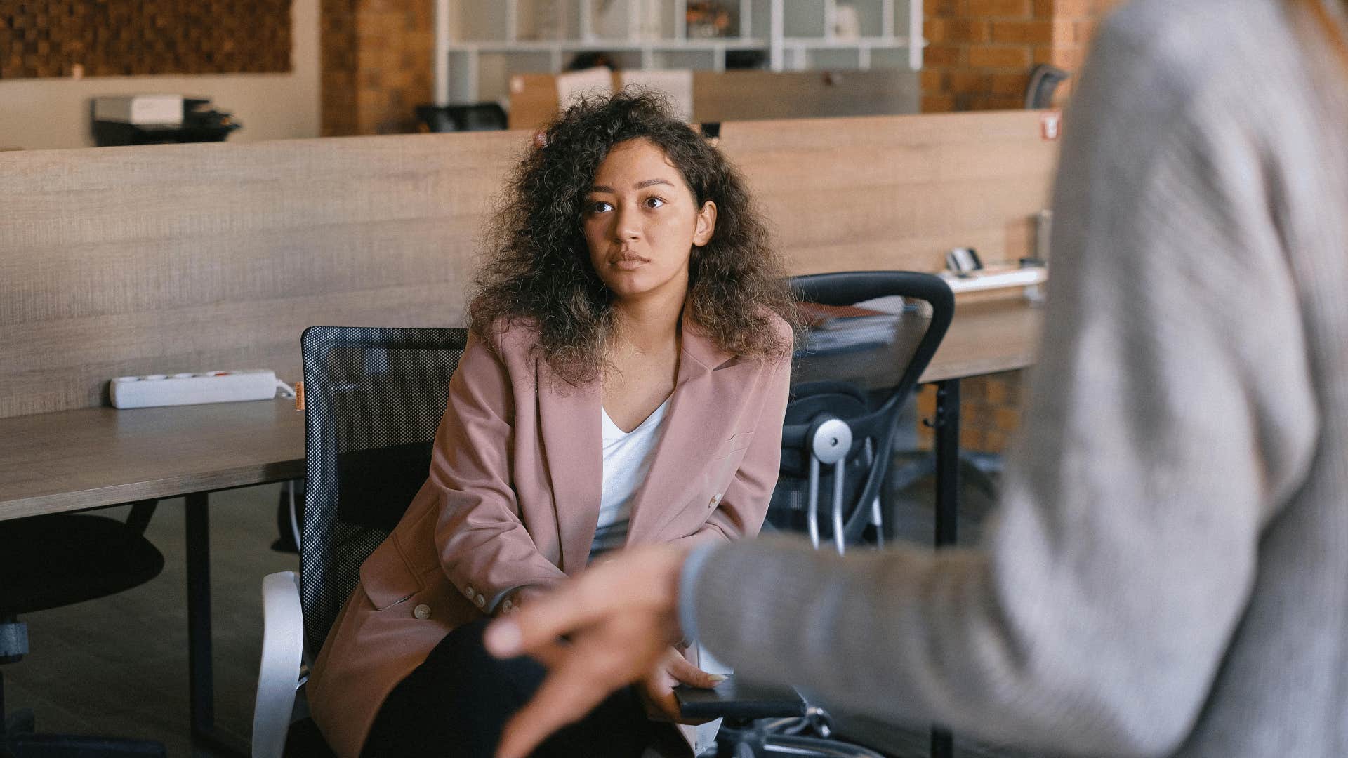 calm woman listening to colleagues