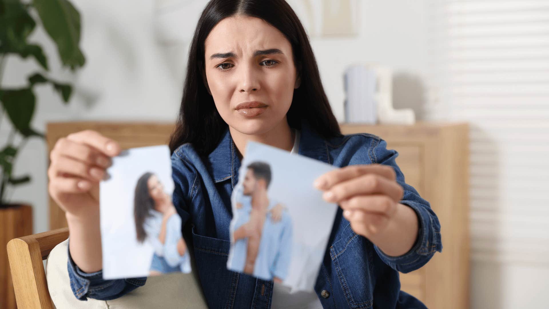 woman tears photo of couple