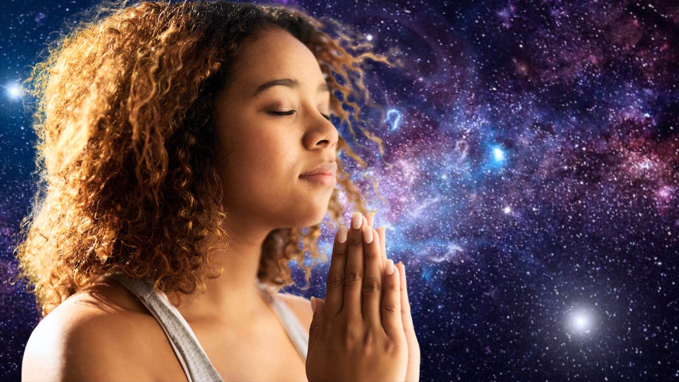 woman meditating manifesting with galaxy background