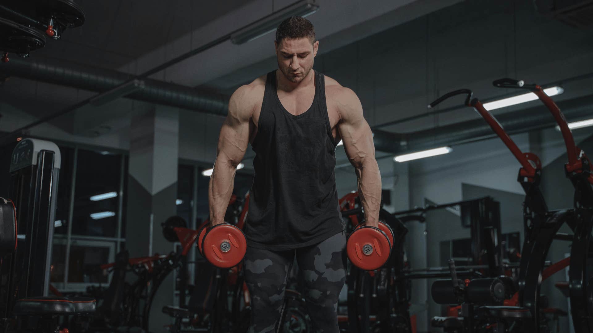 man in gym holding weights