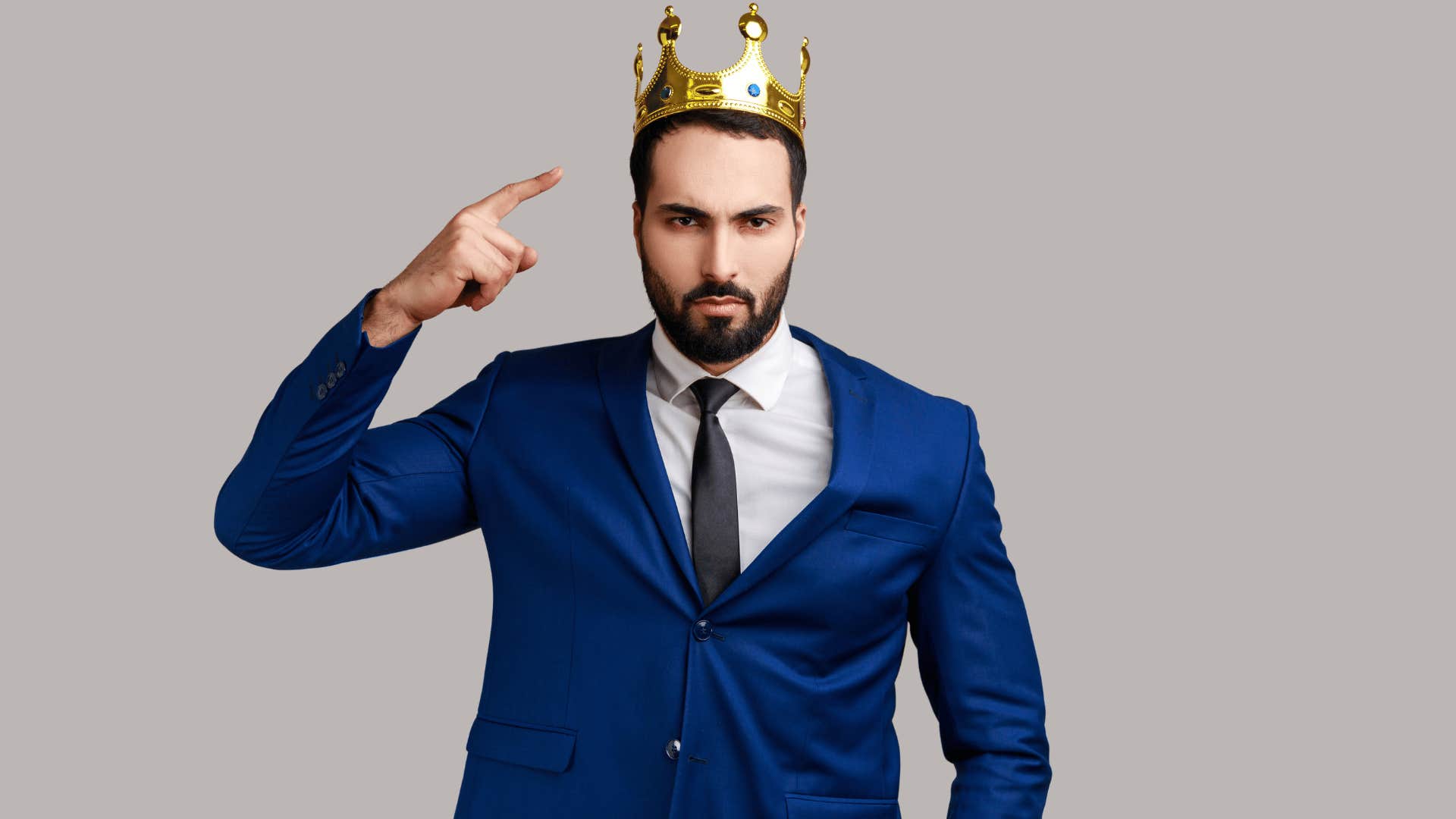 man pointing to his crown