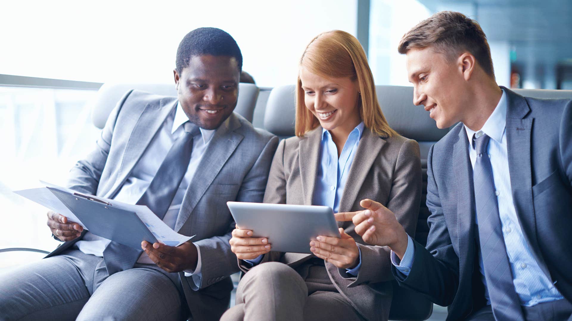 female professional working alongside two male professionals