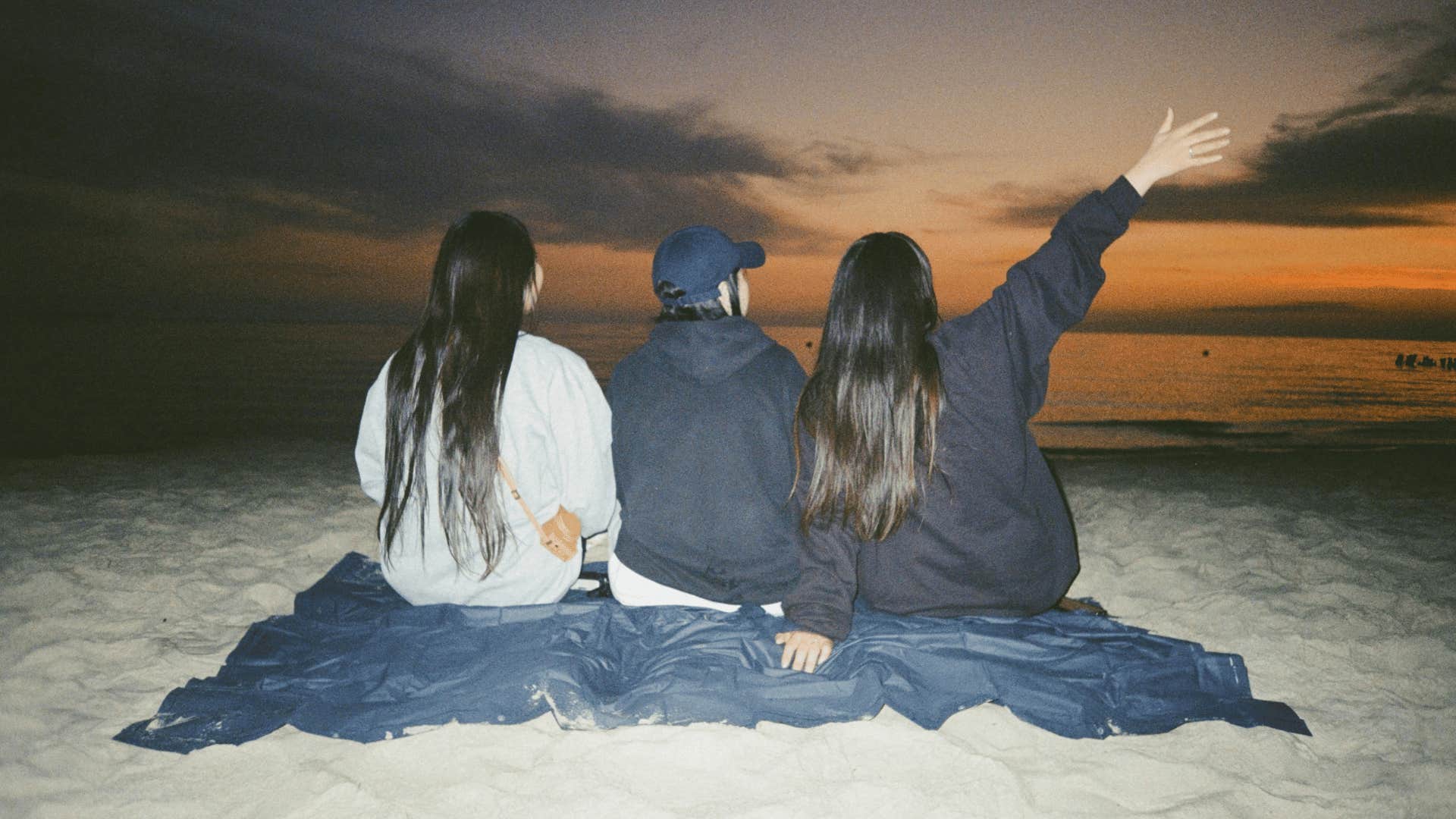 group of friends at sunset on beach