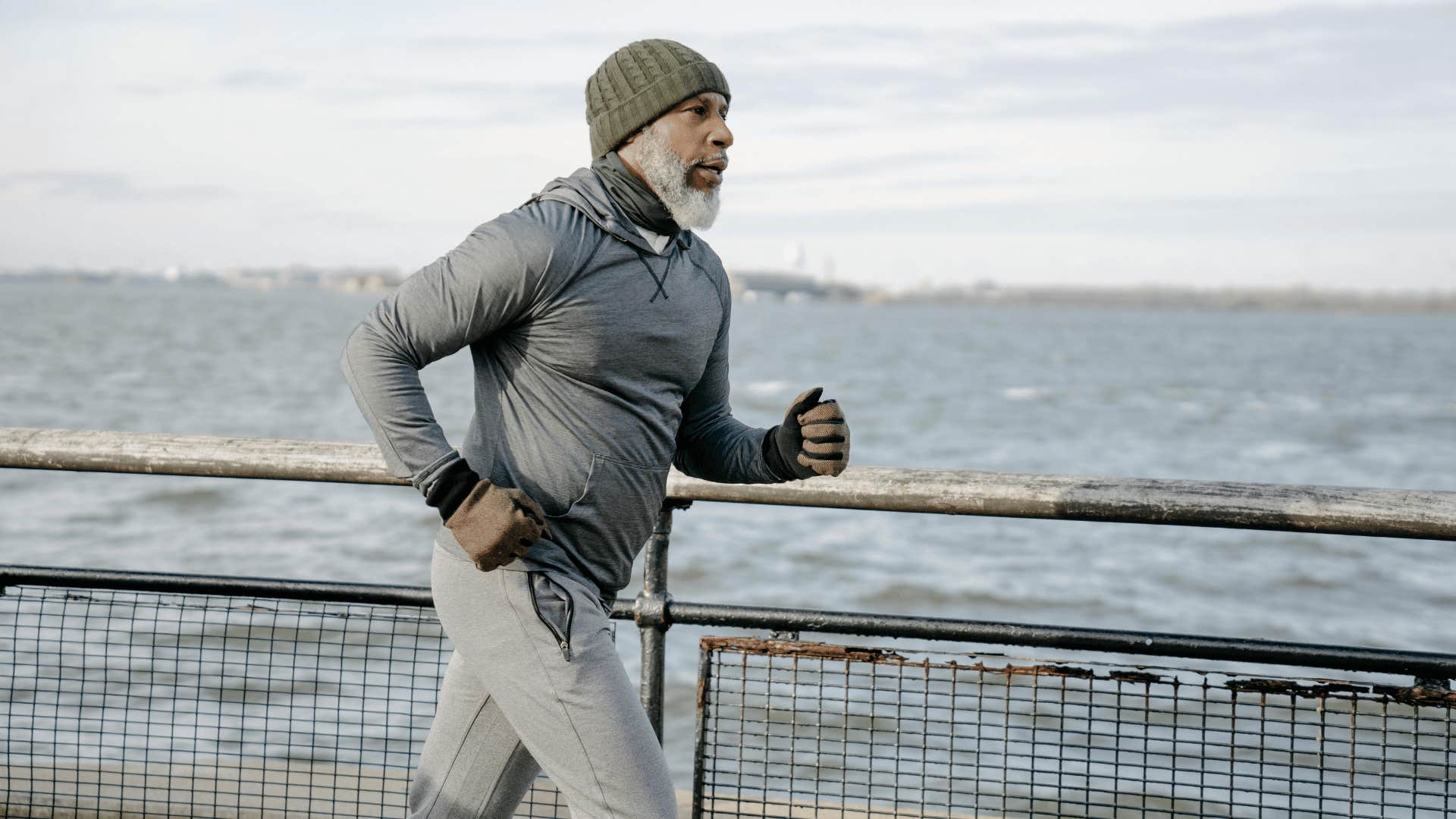 older gentleman running along embankment