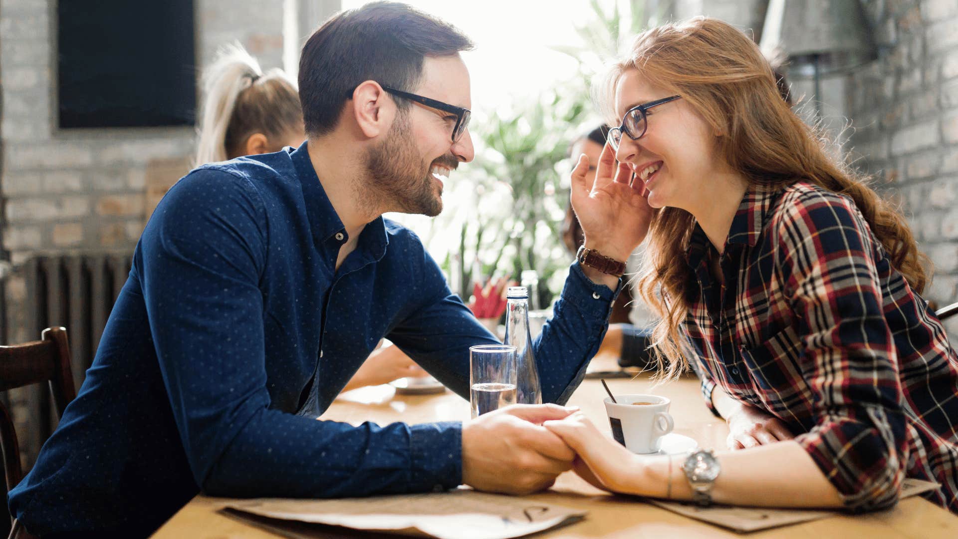 happy couple holding hands in a restaurant