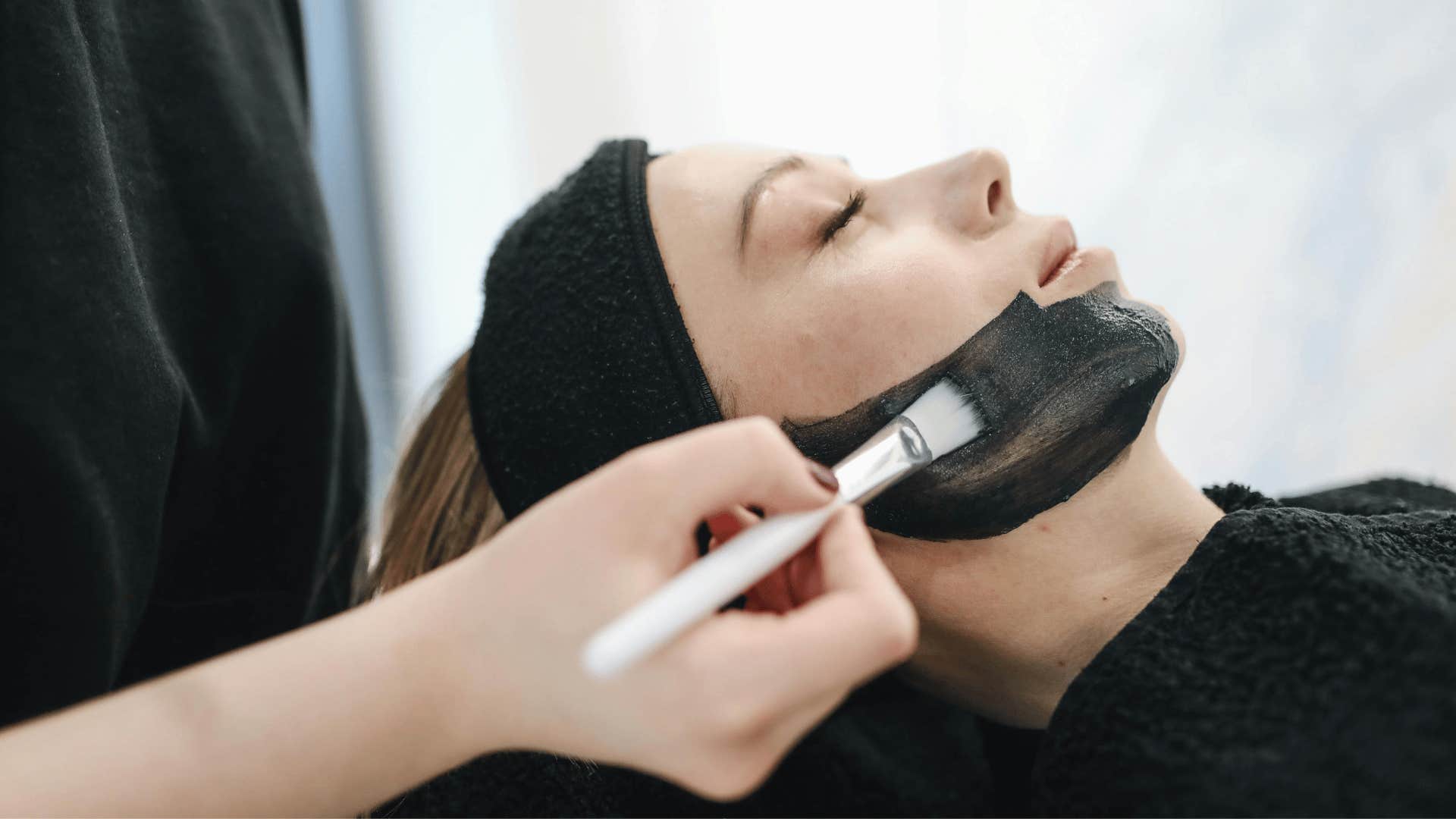 woman getting face mask applied