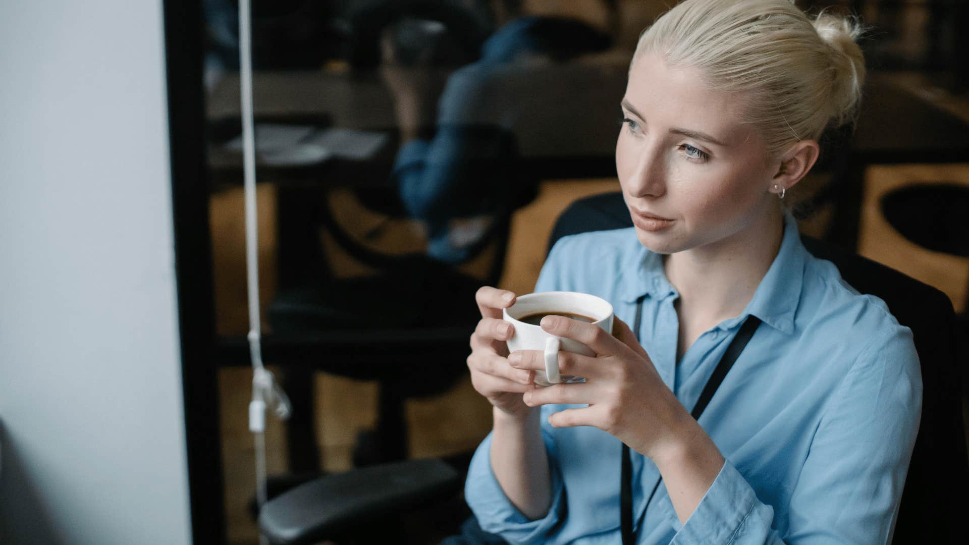 corporate woman drinking coffee while taking a break